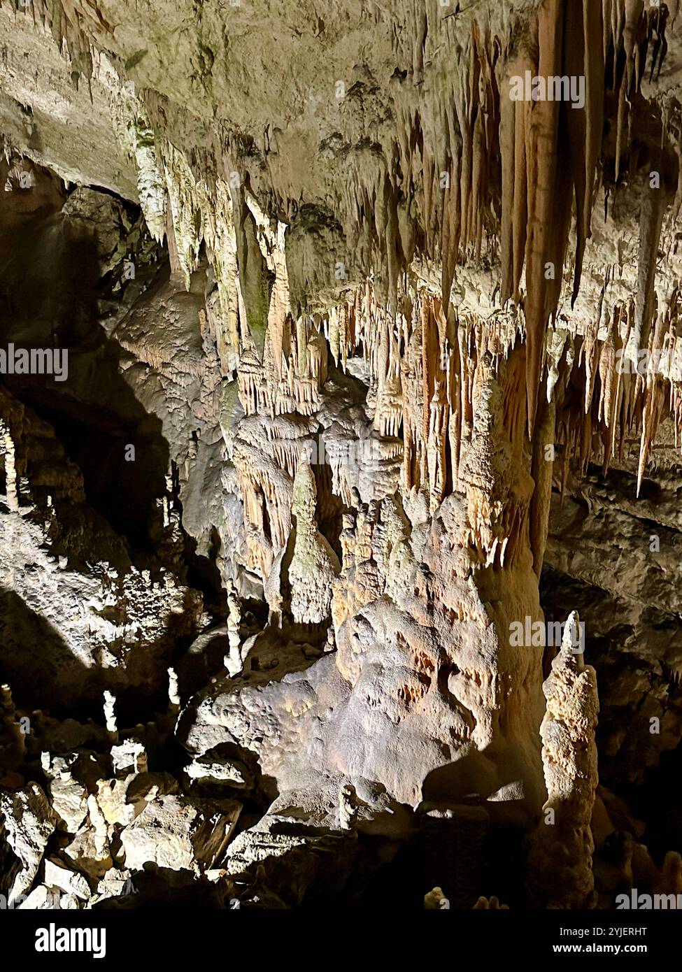 A photography captures a close-up of vibrant stalactites within a secluded cave. - Smartphone Captured Stock Image