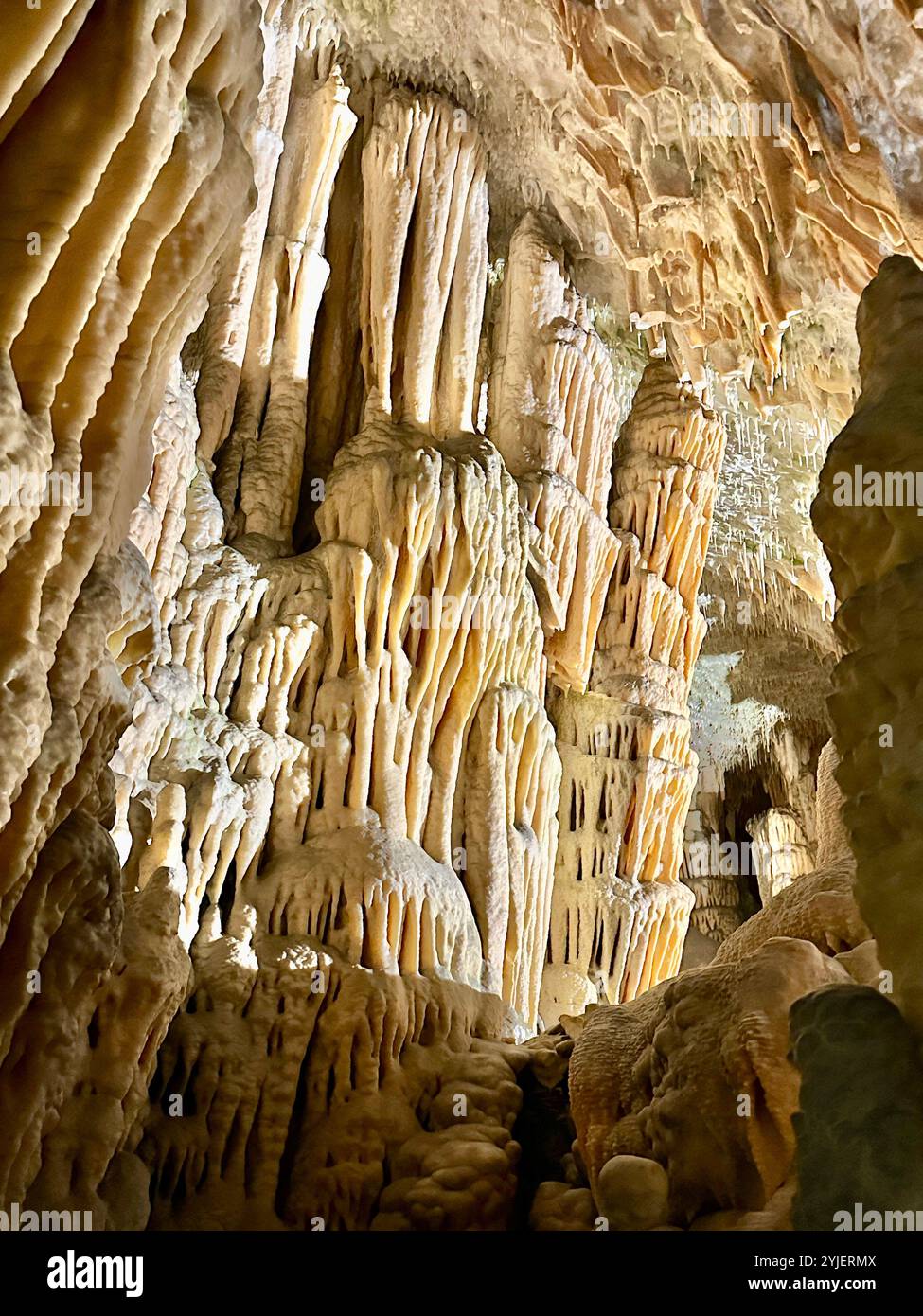 A photography captures a close-up of vibrant stalactites within a secluded cave. - Smartphone Captured Stock Image