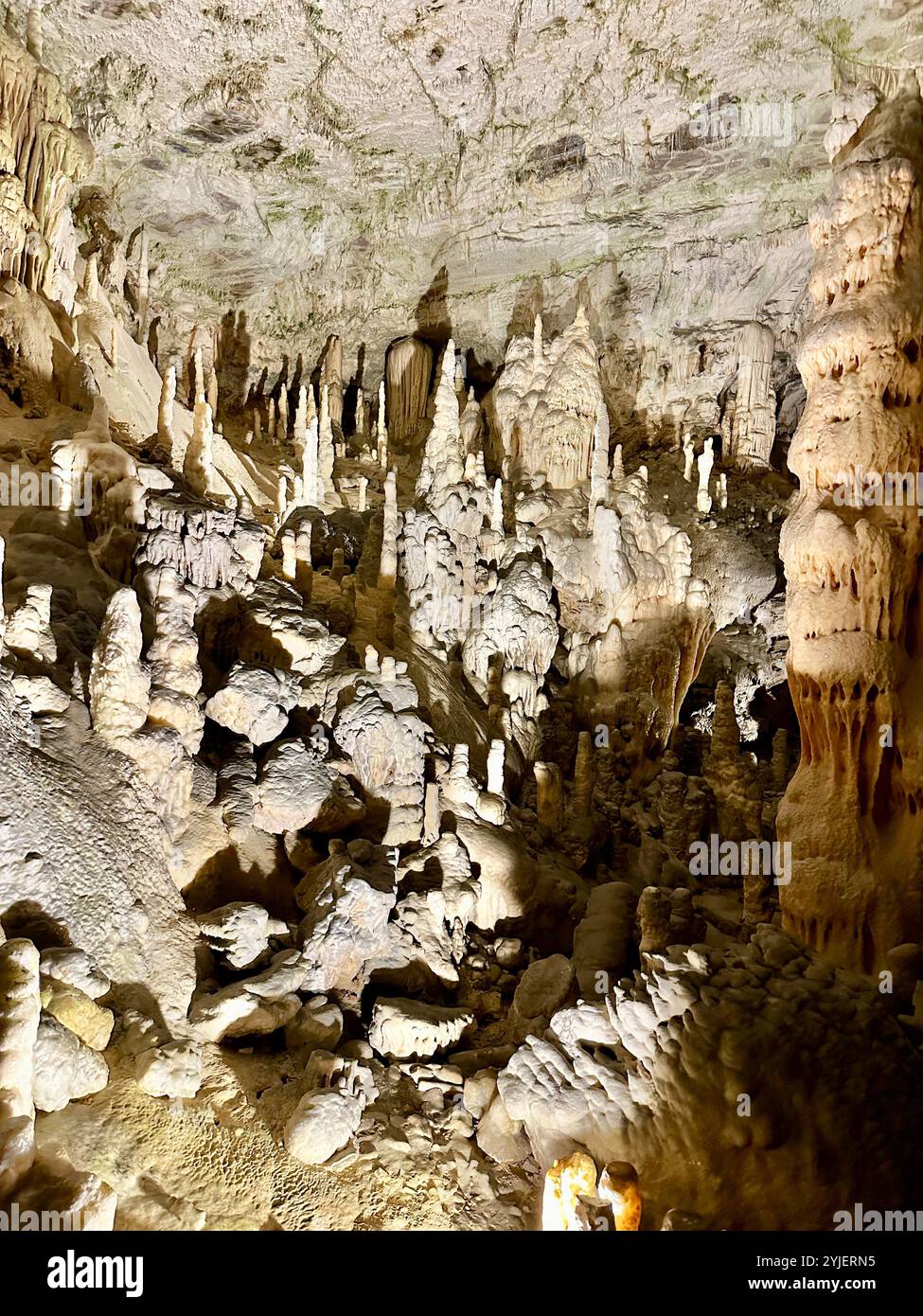 A photography captures a close-up of vibrant stalactites within a secluded cave. - Smartphone Captured Stock Image