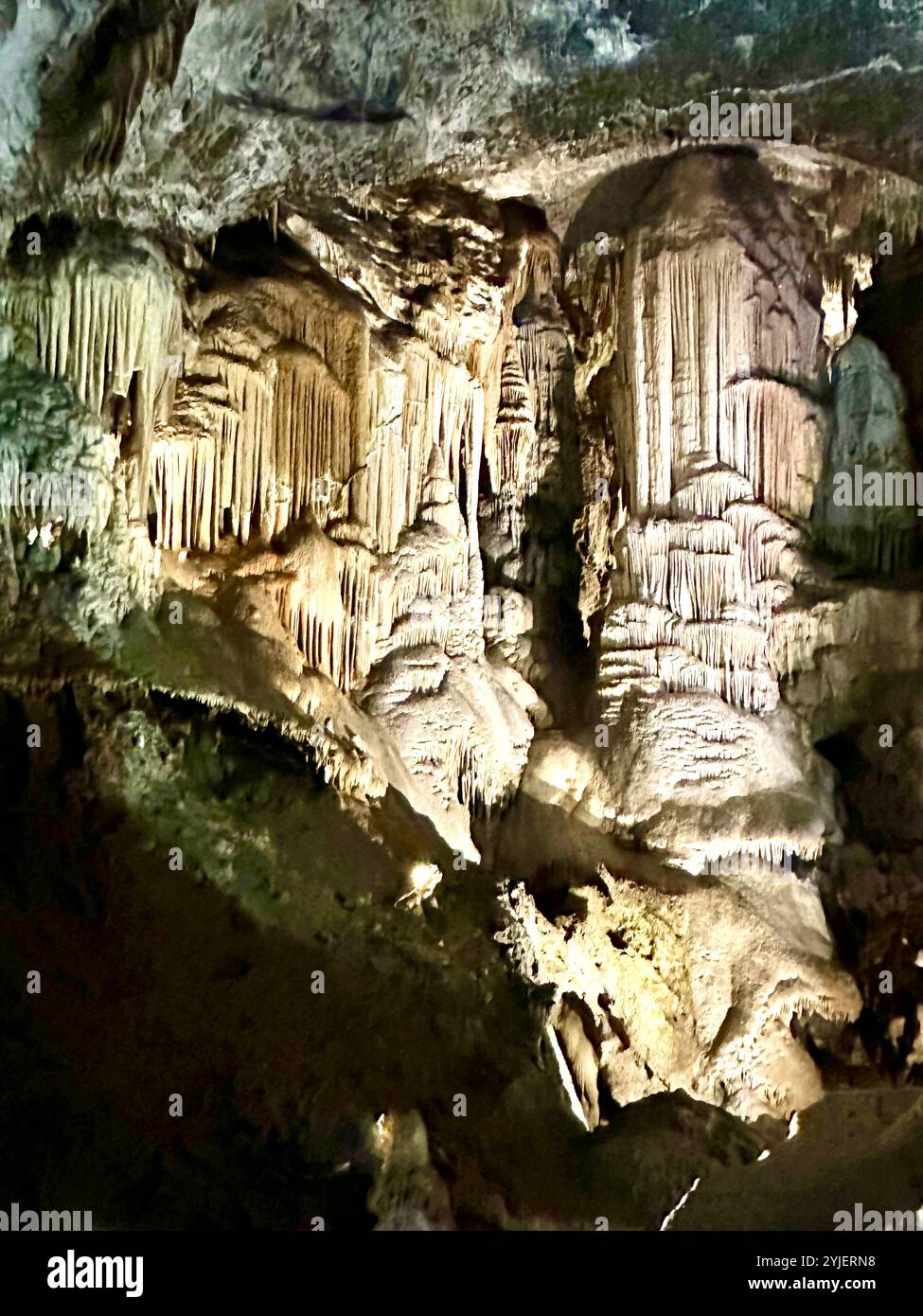 A photography captures a close-up of vibrant stalactites within a secluded cave. - Smartphone Captured Stock Image