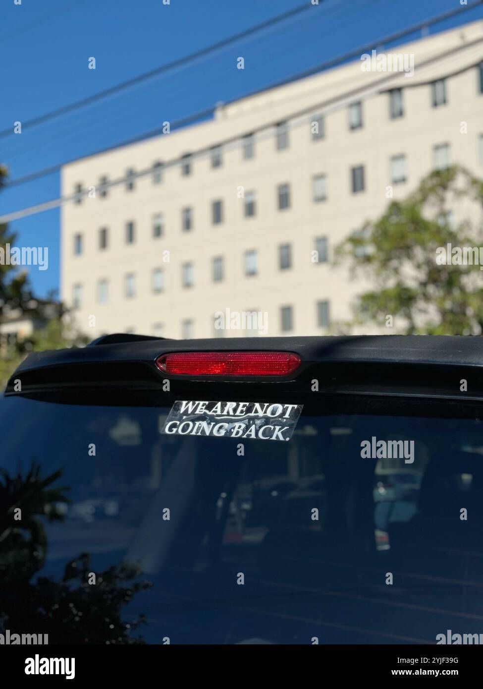 Car sticker says 'We Are Not Going Back', a slogan from the Kamala Harris campaign during the 2024 election. - Smartphone Captured Stock Image
