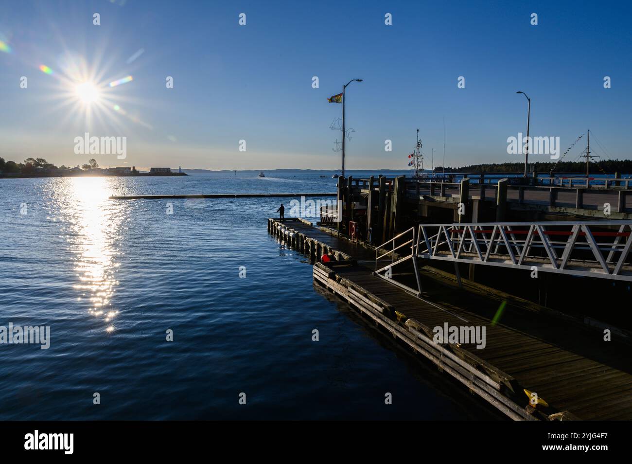 Wharf and harbor scenes as sun rises in St. Andrews, New Brunswick, Canada. Stock Photo