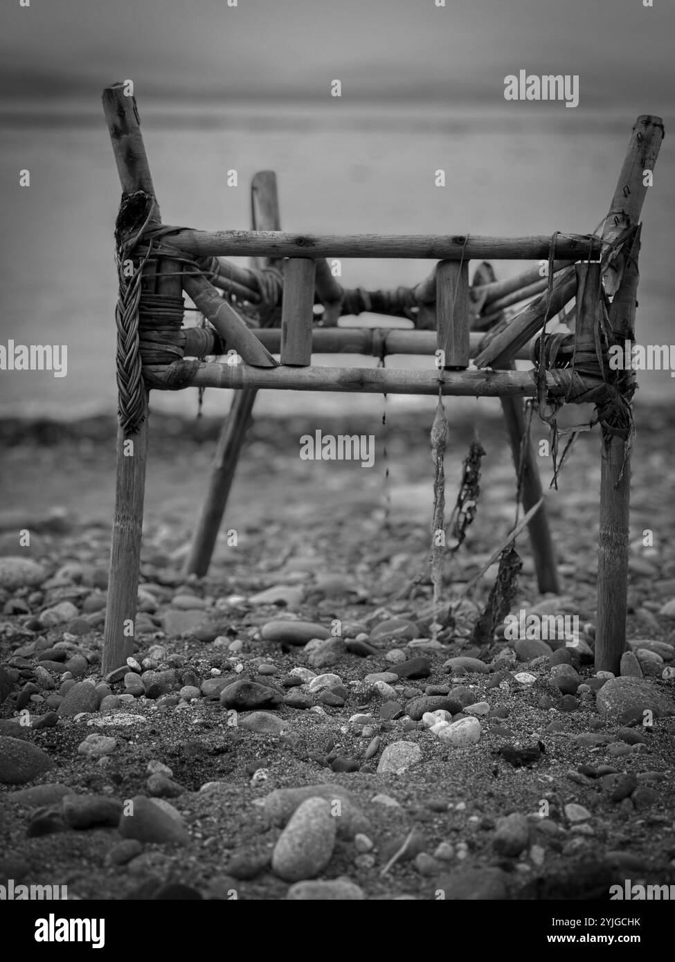 A broken bamboo chair washed up on the shore after a storm in the Pacific Northwest - Smartphone Captured Stock Image