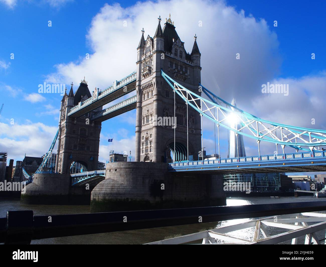 Sun reflecting of the shard building behind tower bridge in London, United Kingdom Stock Photo