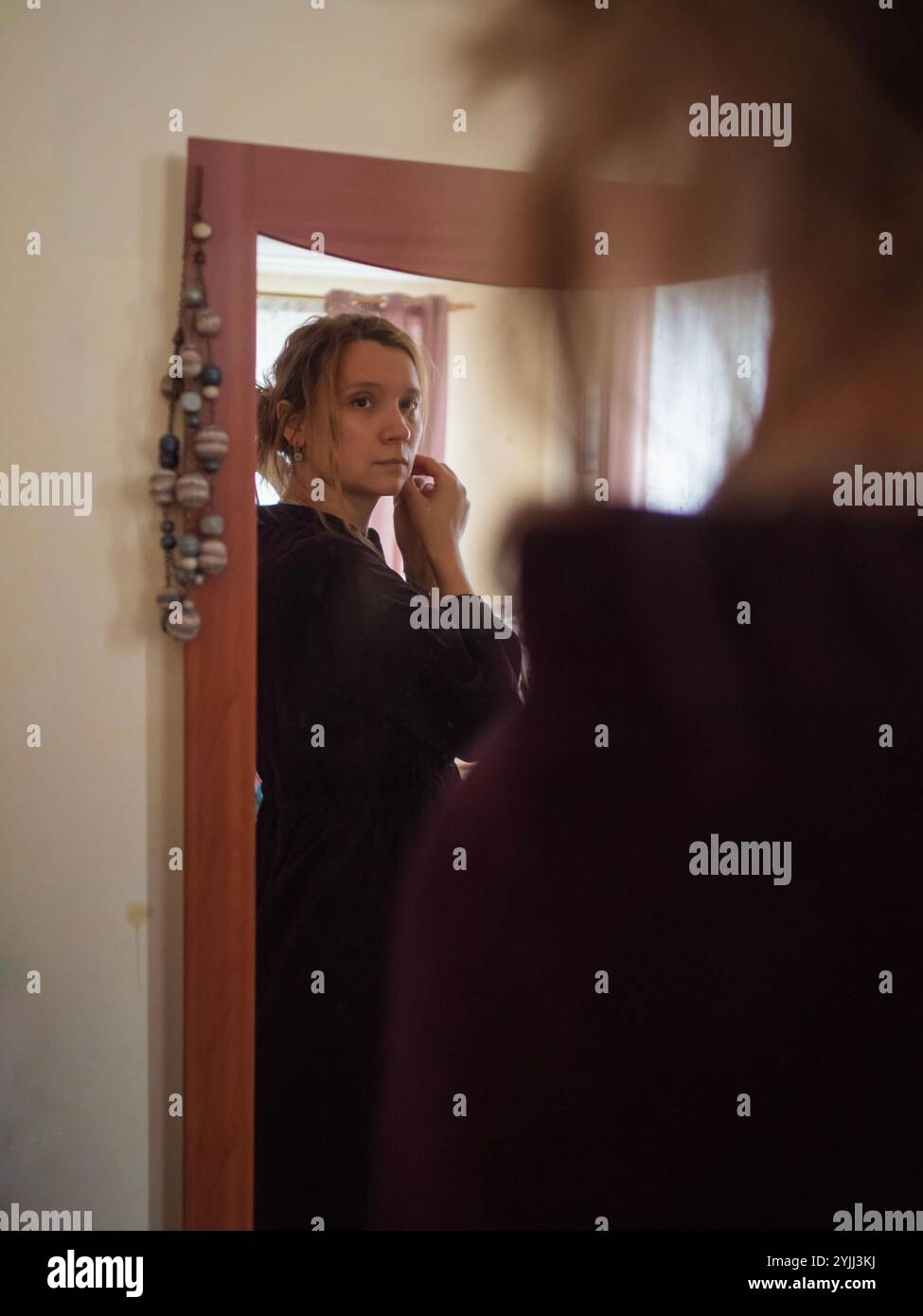 Young Woman Looking at the Mirror Stock Photo