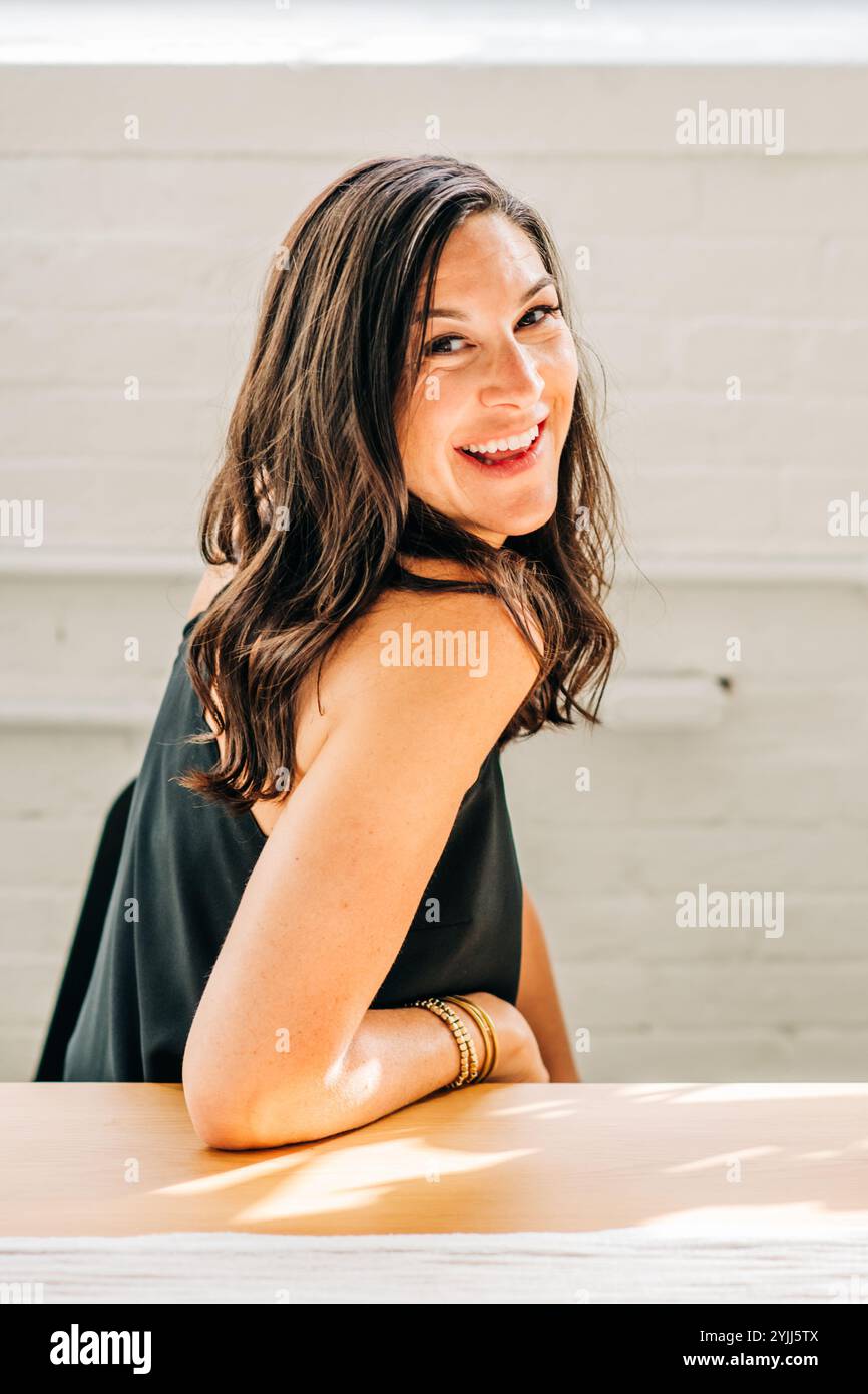 Woman in black top indoors hi-res stock photography and images - Alamy