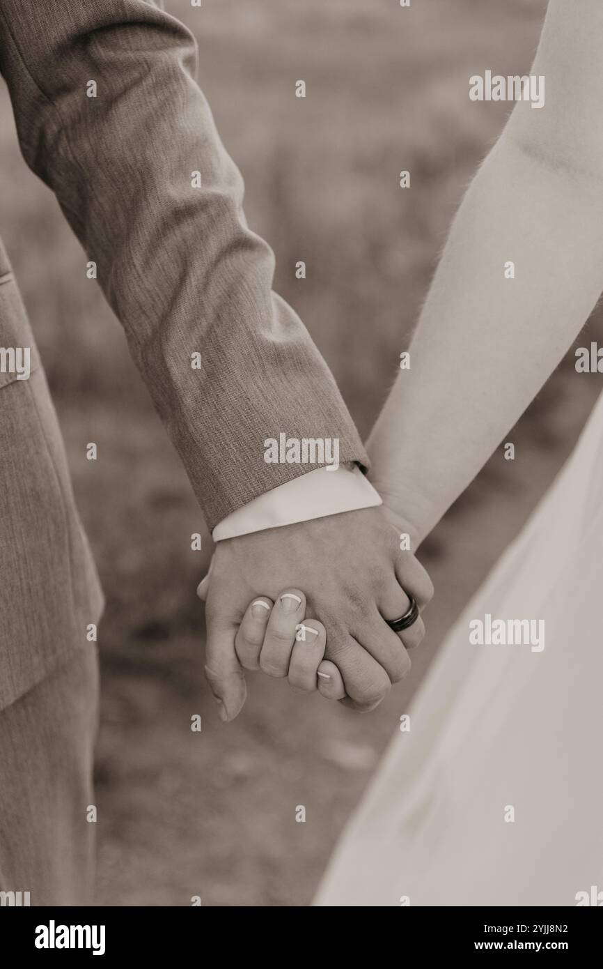 Wedding couple holding hands in Black and White Stock Photo - Alamy