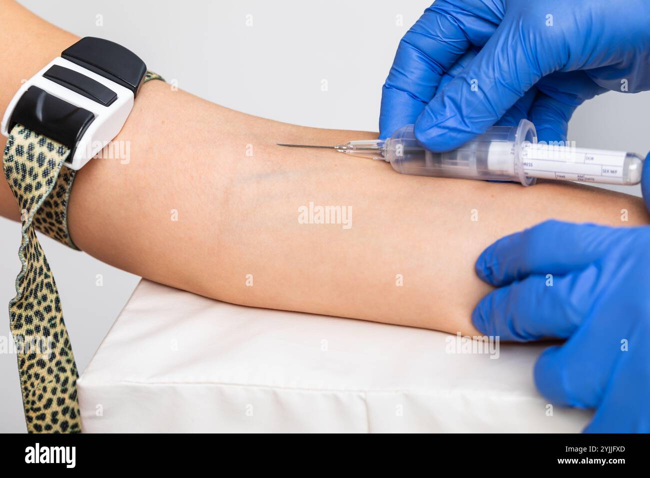 Close-up shot of healthcare worker wearing gloves takes a blood sample ...
