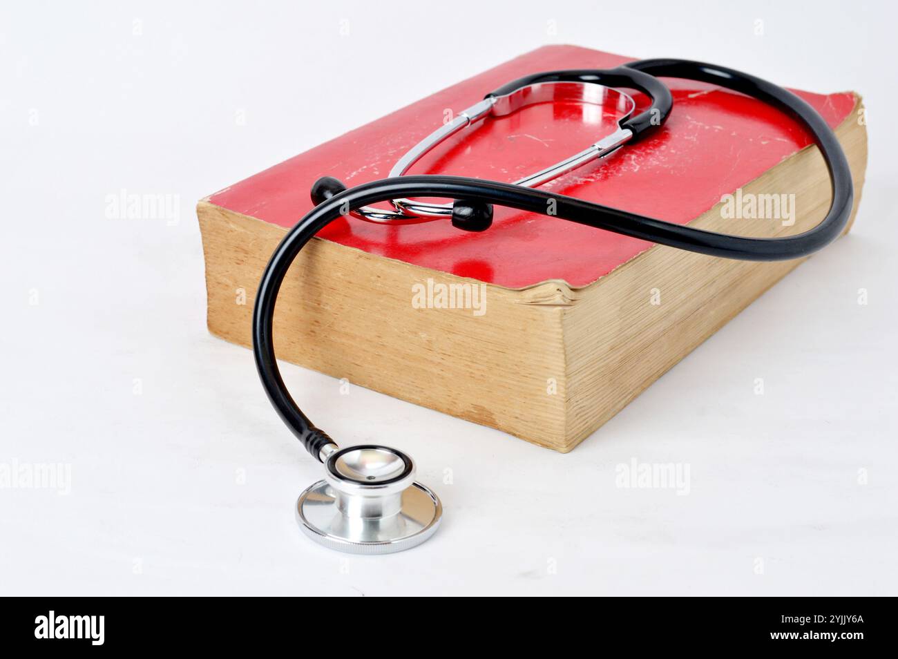 stethoscope at red old book on white background Stock Photo - Alamy