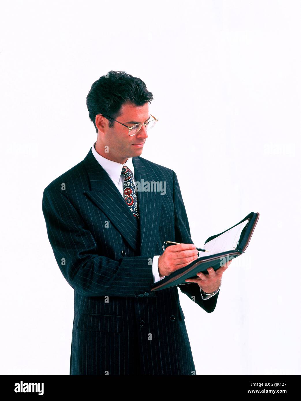 Business. & professions. Young man executive using personal organiser. Stock Photo