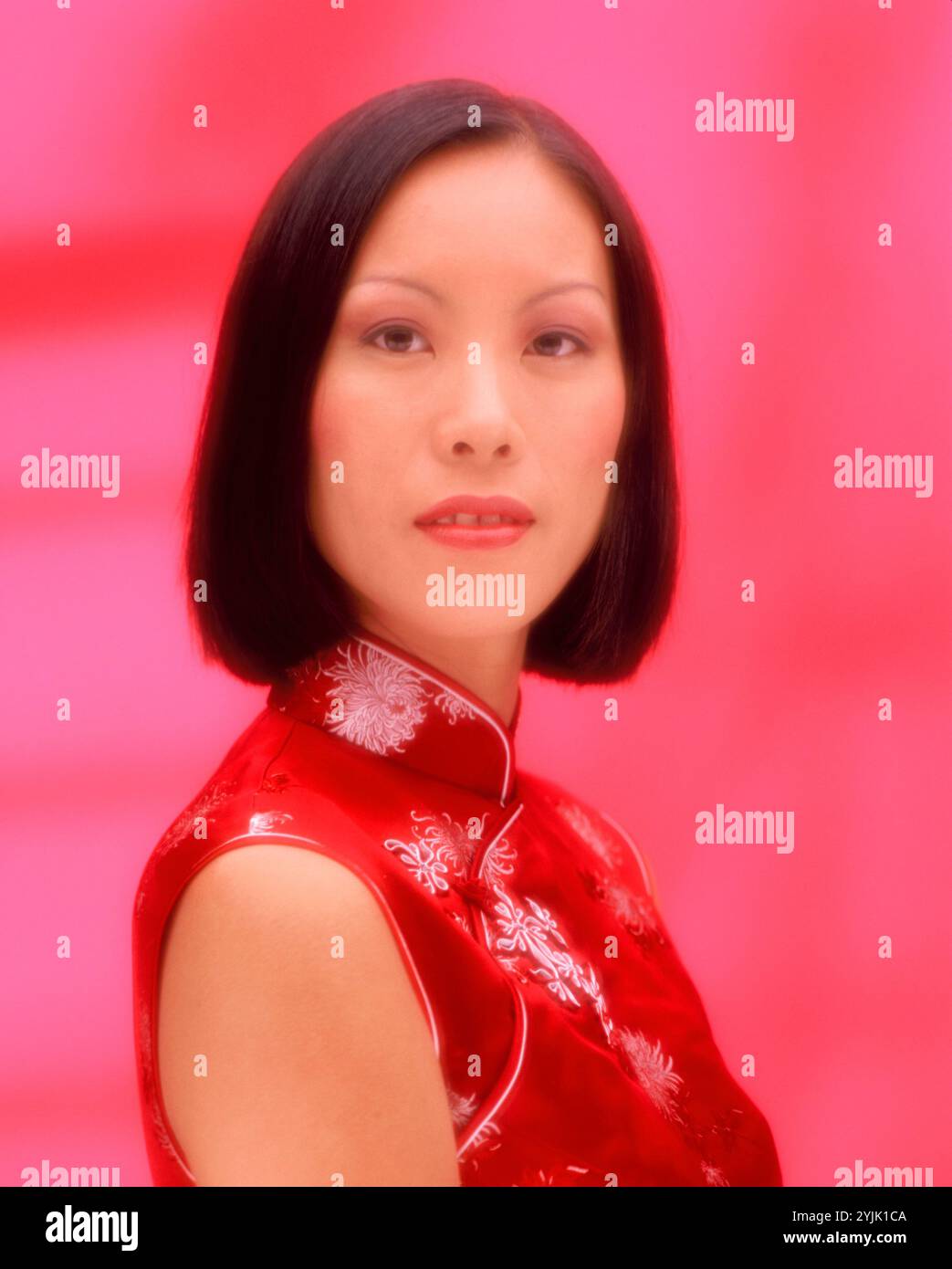 Studio portrait of young woman in traditional Chinese dress. Stock Photo