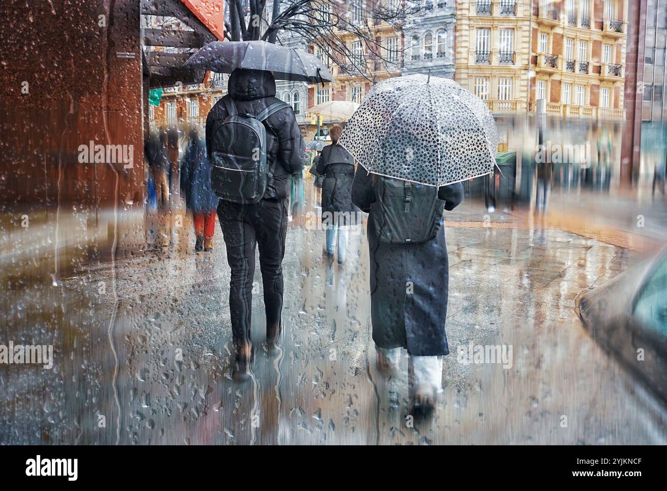 Pedestrian on the street with an umbrella in rainy days in winter ...