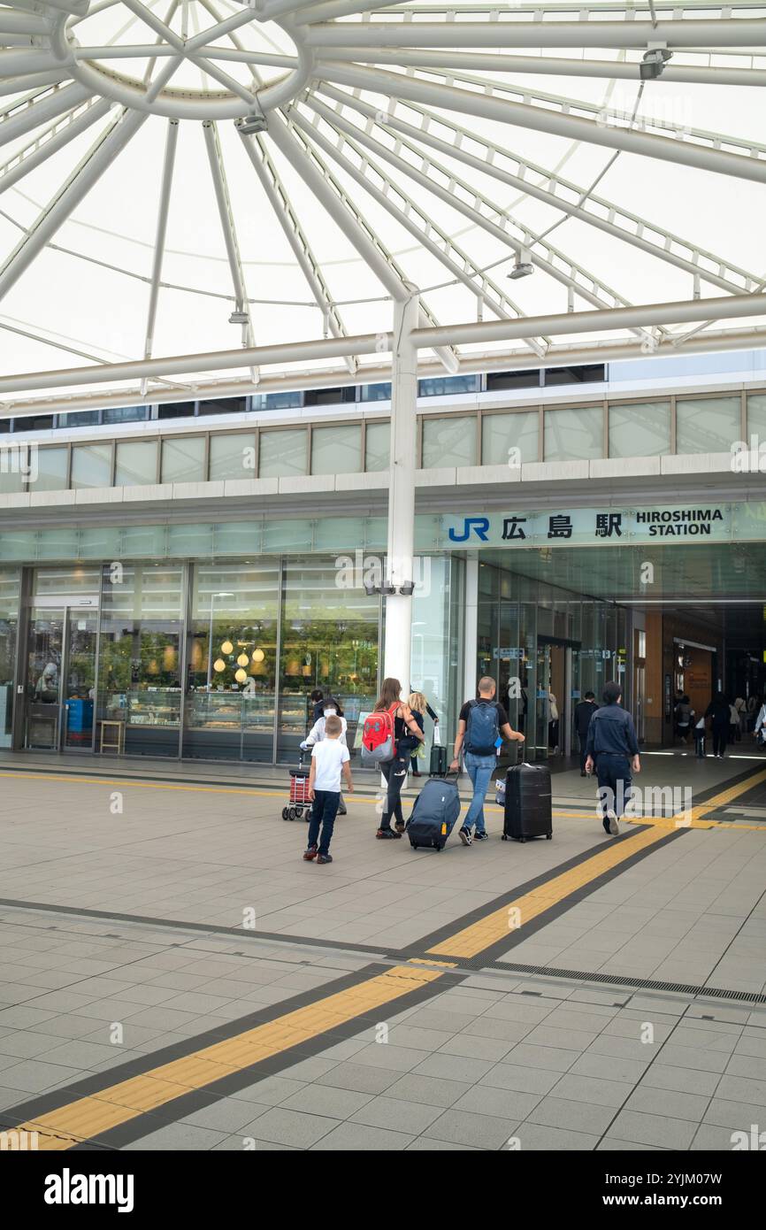 Passengers enter the Railway Station in Hiroshima Japan Stock Photo - Alamy