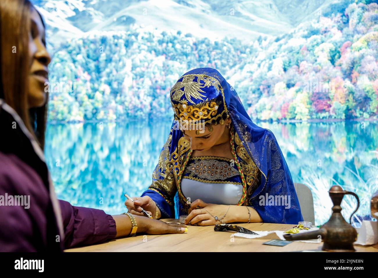 Baku, Azerbaijan. 15th Nov, 2024. Native Azeri woman present henna paining technique, a part of Azeri tradition in COP29 Green Zone during United Nations Climate Change Conference COP29, an event held by UNFCCC in Baku Olympic Stadium in Baku, the capital of Azerbaijan on November 15, 2024. COP29, running from November 11-22, focuses on climate financing. (Photo by Dominika Zarzycka/Sipa USA) Credit: Sipa USA/Alamy Live News Stock Photo