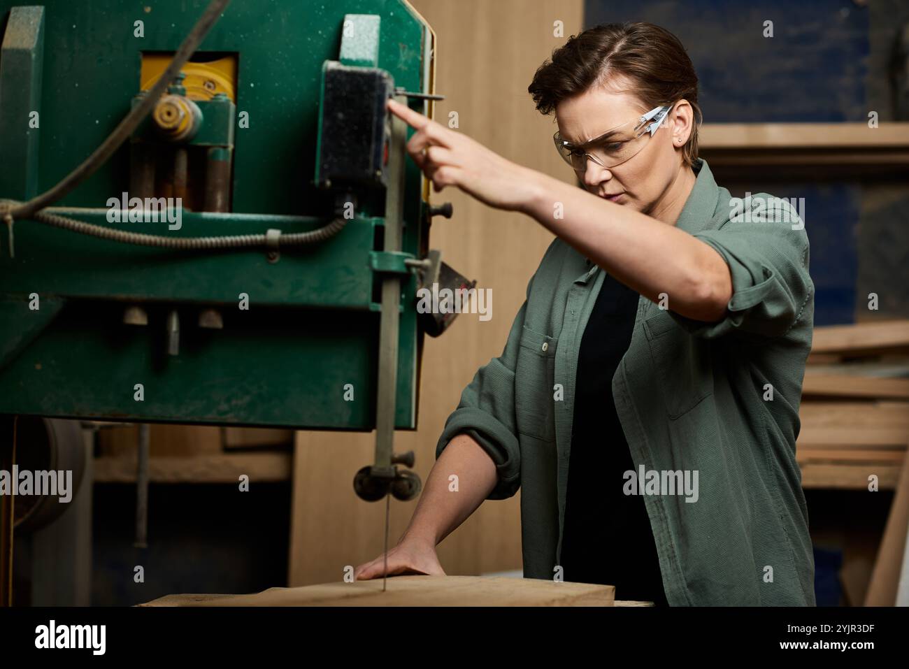 A talented female carpenter focuses on her task as she expertly ...