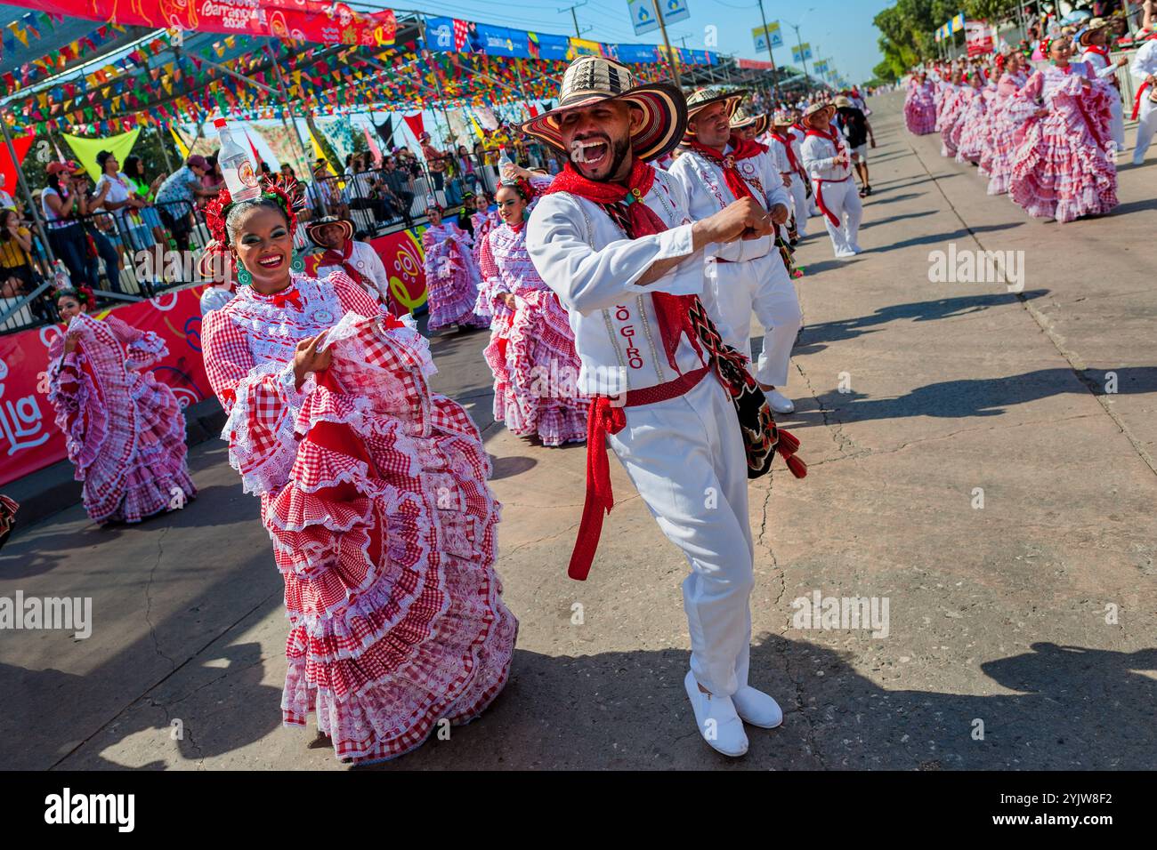 Colombian couples wearing traditional cumbia outfits dance the cumbia