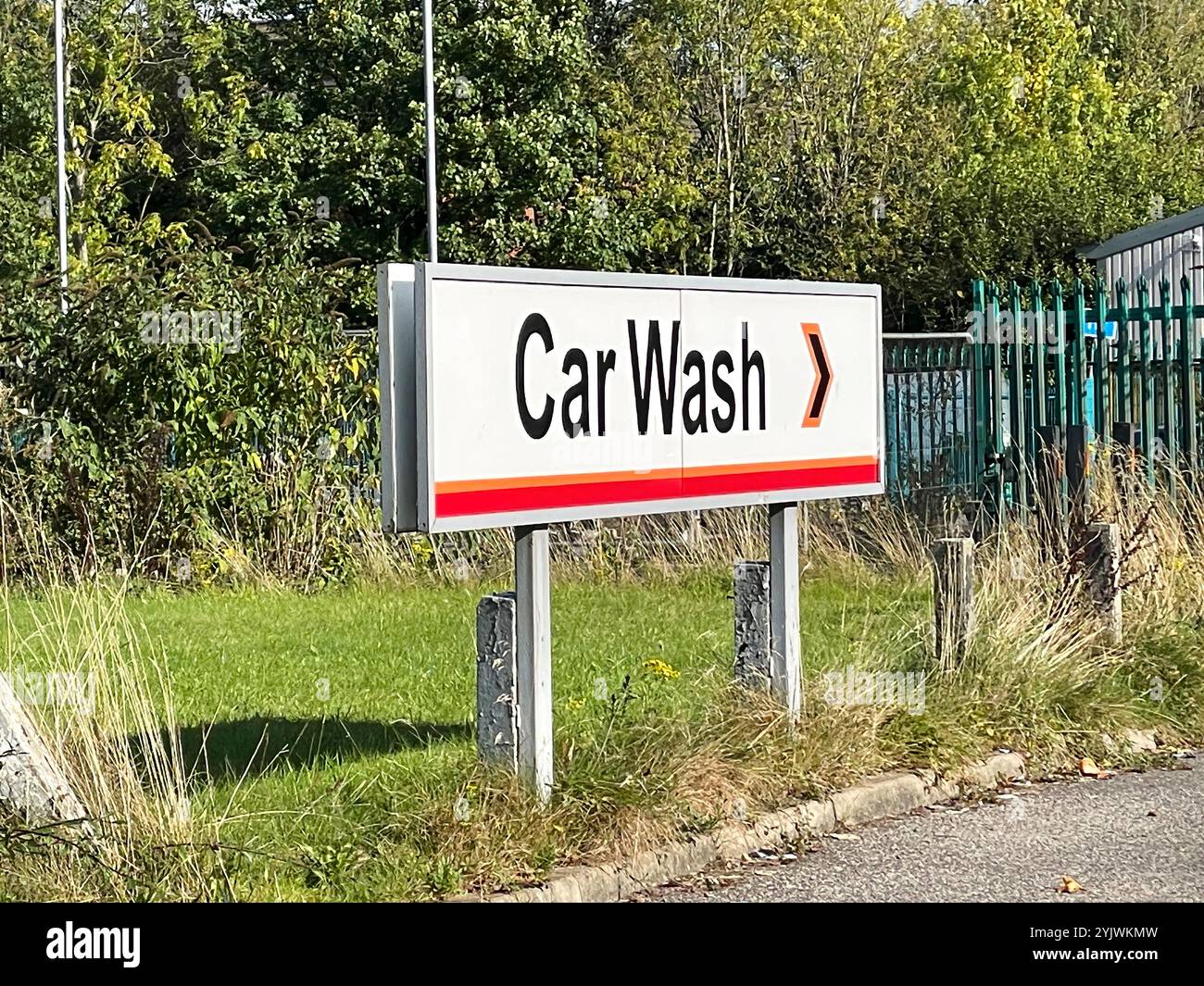 car wash facility with signage on a sunny day. The setting is ...