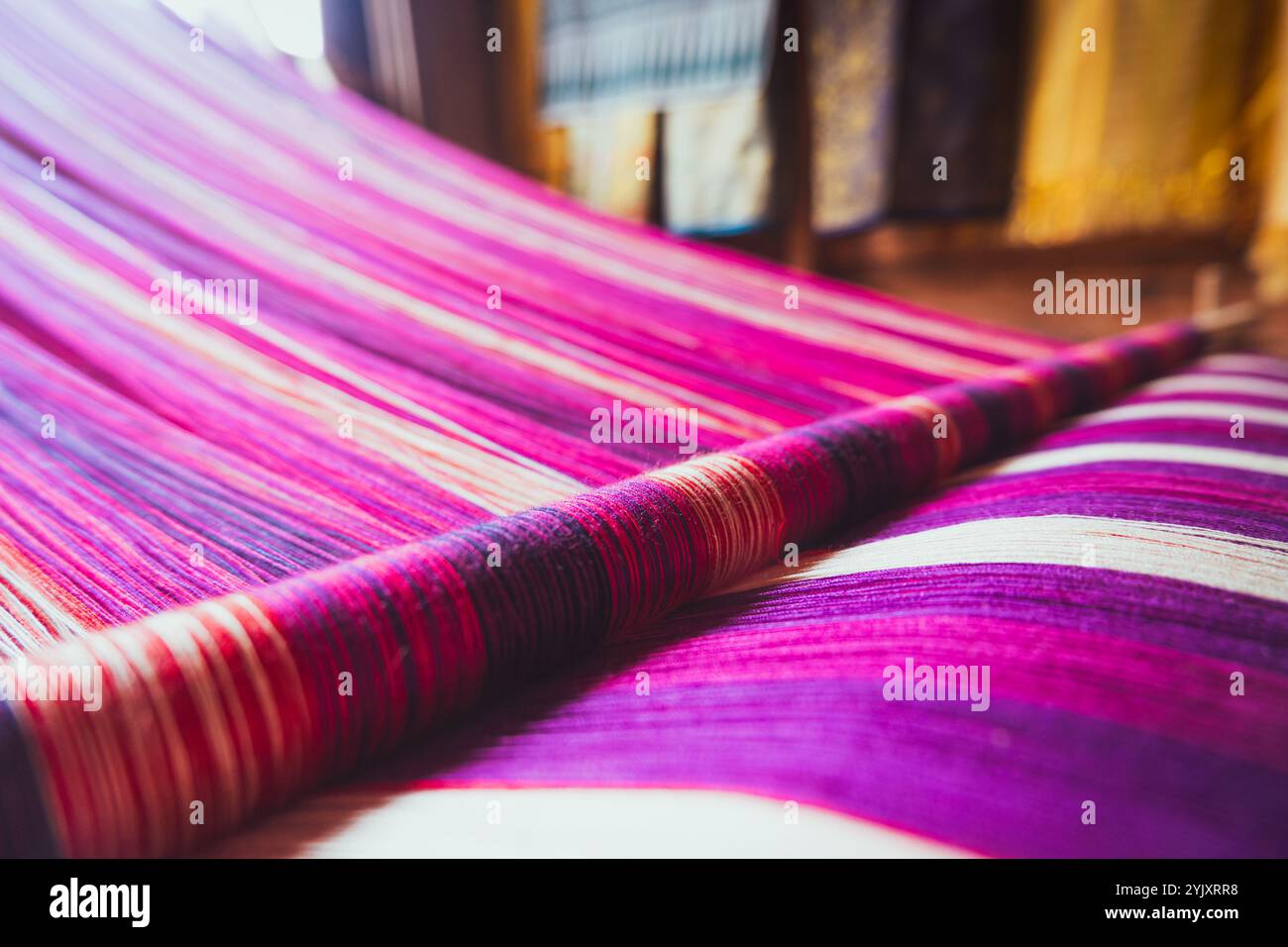 Woven yarn with colorful patterns being processed on the loom Stock ...