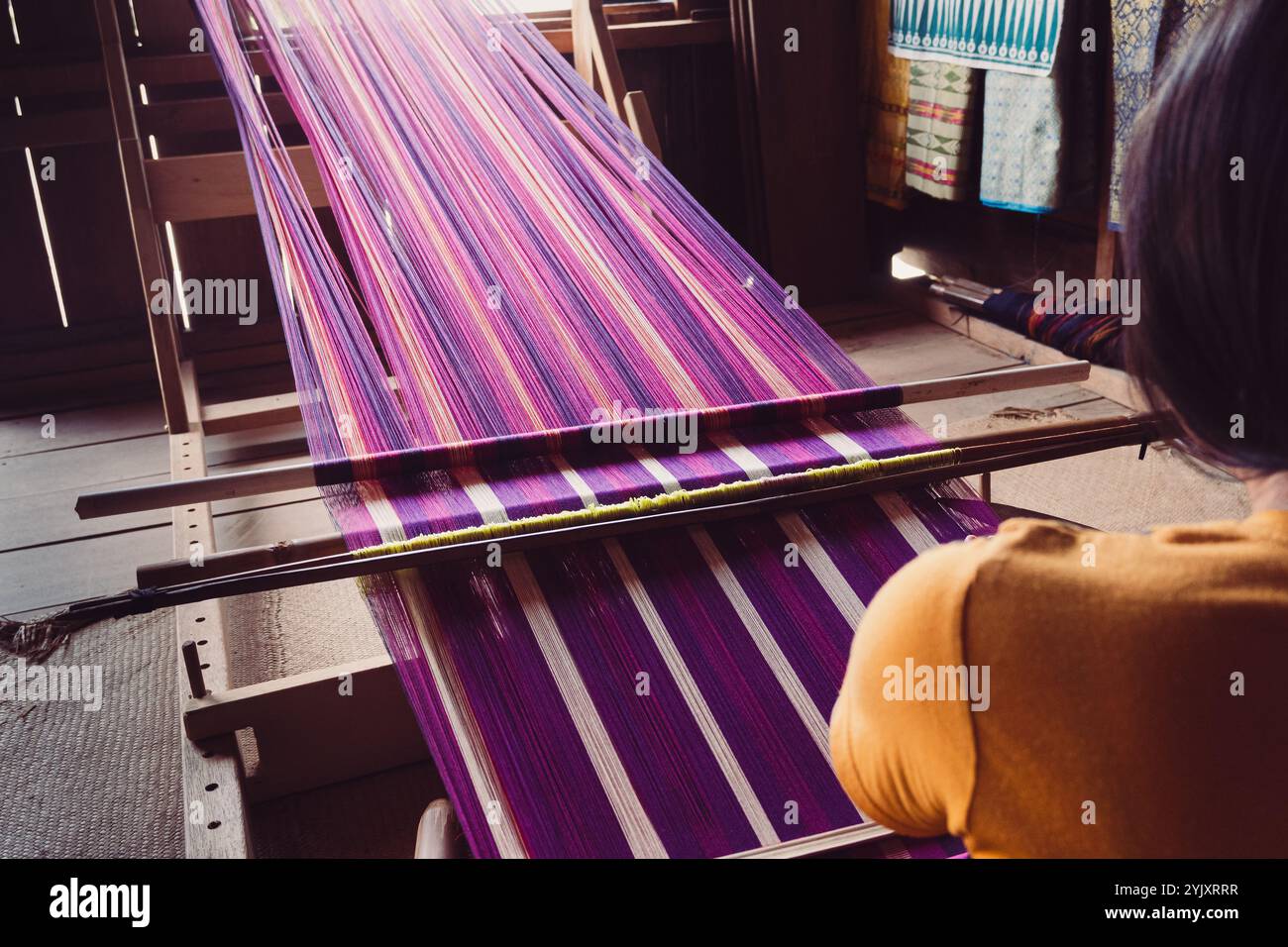 A Torajan Sa'dan weaver woman works on her weaving, South Sulawesi ...
