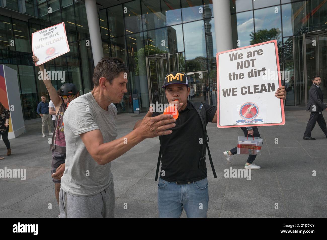 London, UK. 7th July 2017. A man tries to intimidate a cleaner at the protest by the Cleaners and Allied Independent Workers Union (CAIWU) outside Facebook's offices in London against the 'Ugly Face of Facebook' calling for the cleaners there to be paid the London Living Wage and for a proper investigation into allegations of racism, bullying and nepotism by the manager on site. He went on to try to intimdate other proesters and me before being led away by secuirty. There are two redundant levels of management at these offices; rather than employing cleaners directly, Facebook uses the propert Stock Photo