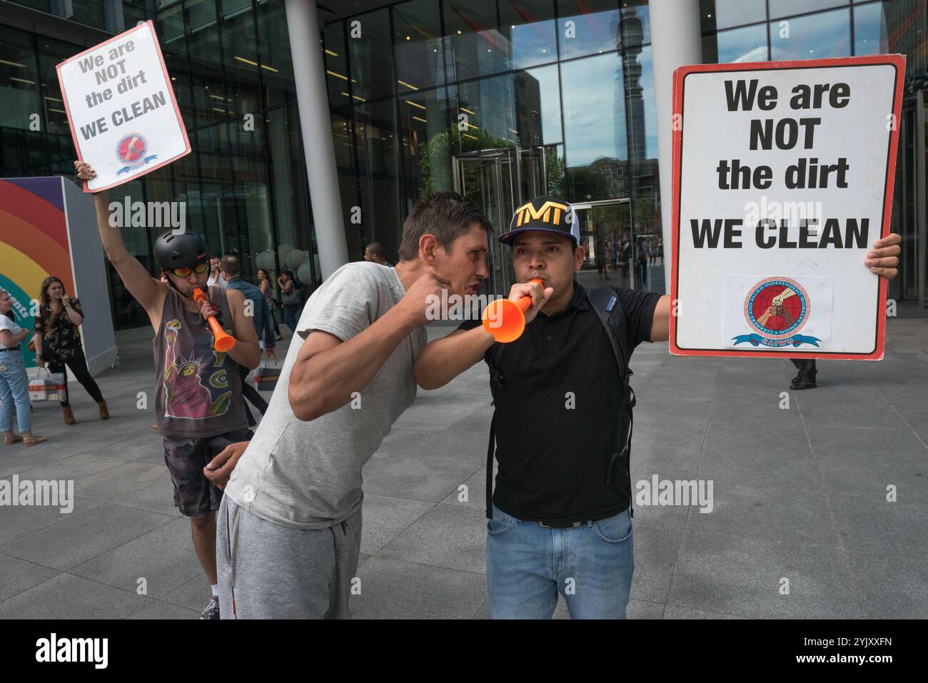 London, UK. 7th July 2017. A man tries to intimidate a cleaner at the protest by the Cleaners and Allied Independent Workers Union (CAIWU) outside Facebook's offices in London against the 'Ugly Face of Facebook' calling for the cleaners there to be paid the London Living Wage and for a proper investigation into allegations of racism, bullying and nepotism by the manager on site. He went on to try to intimdate other proesters and me before being led away by secuirty. There are two redundant levels of management at these offices; rather than employing cleaners directly, Facebook uses the propert Stock Photo