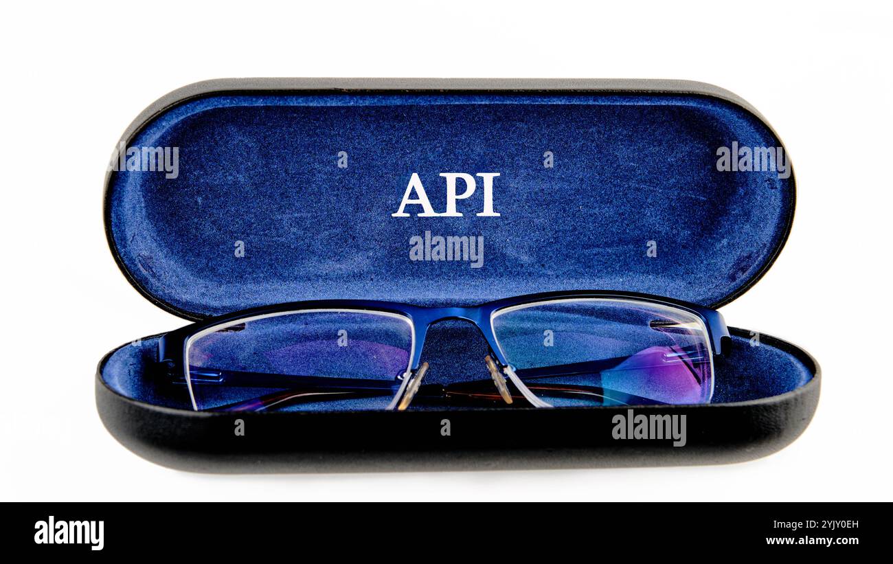 API (application program interface). The concept of technology and development. Phrase, words, text API written on the open case of the glasses case. Stock Photo