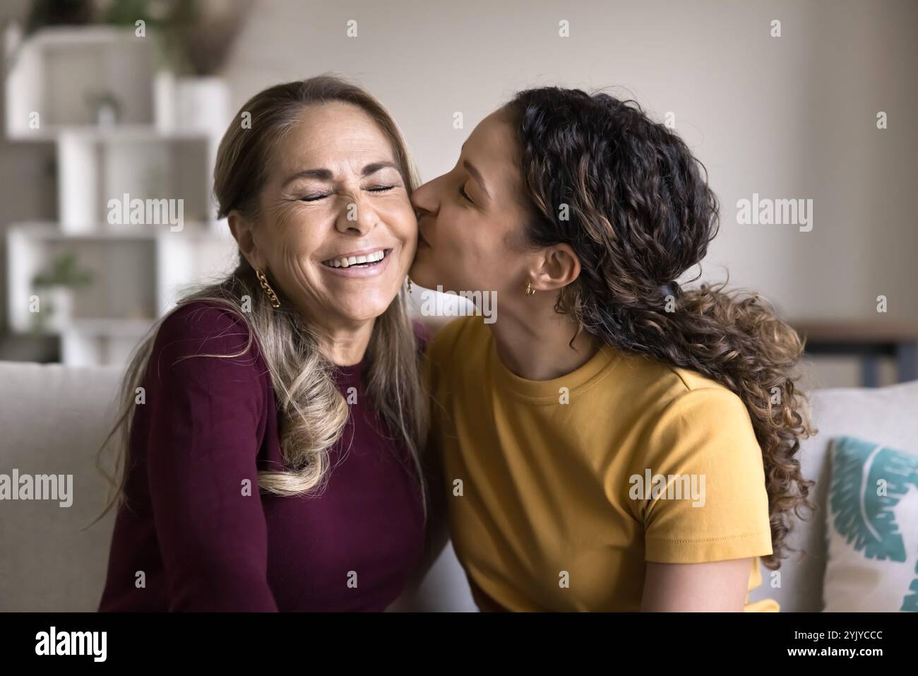 Loving Brazilian daughter woman hugging and kissing happy senior mom Stock Photo - Alamy