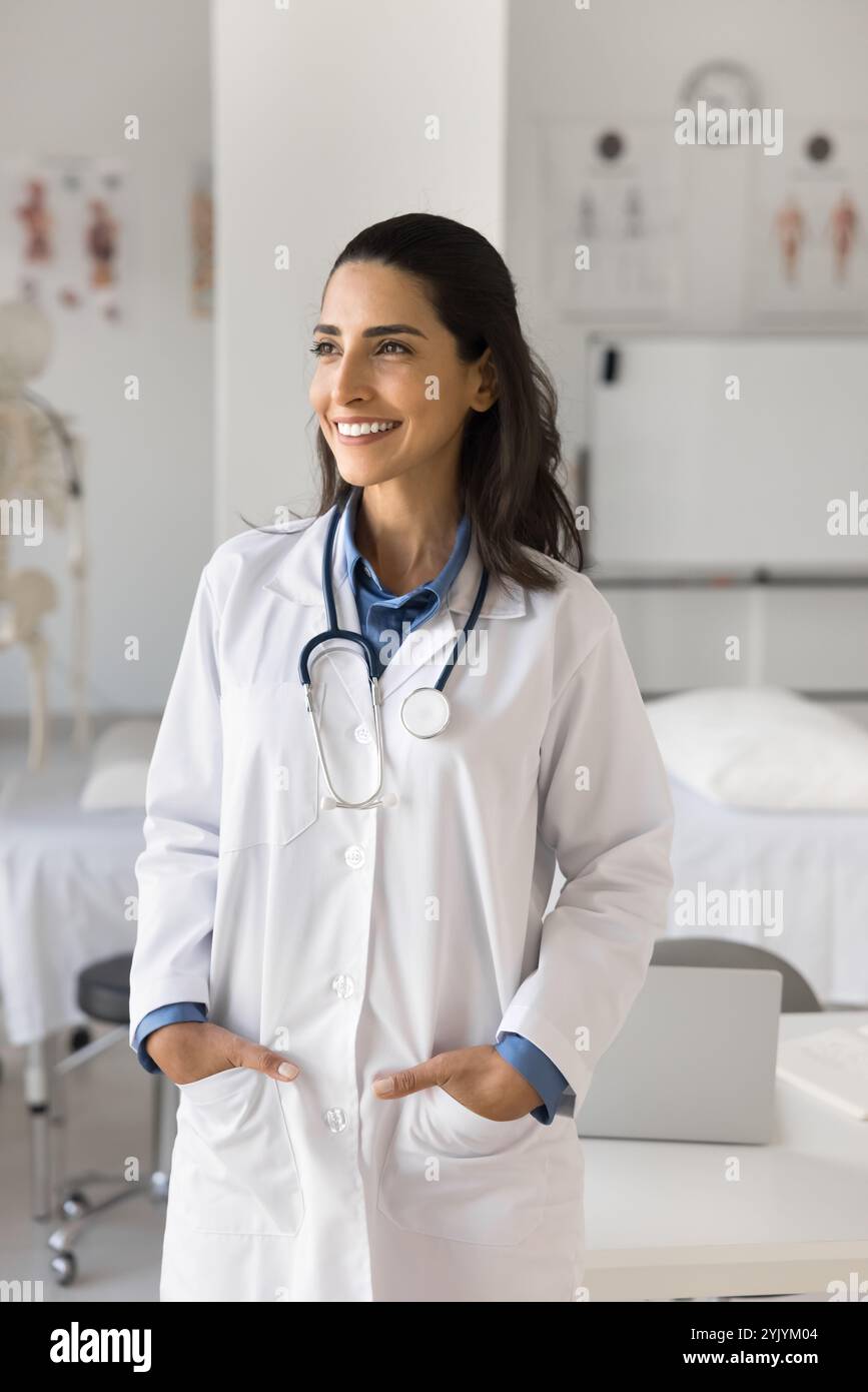 Vertical shot of young successful Latina medical worker Stock Photo