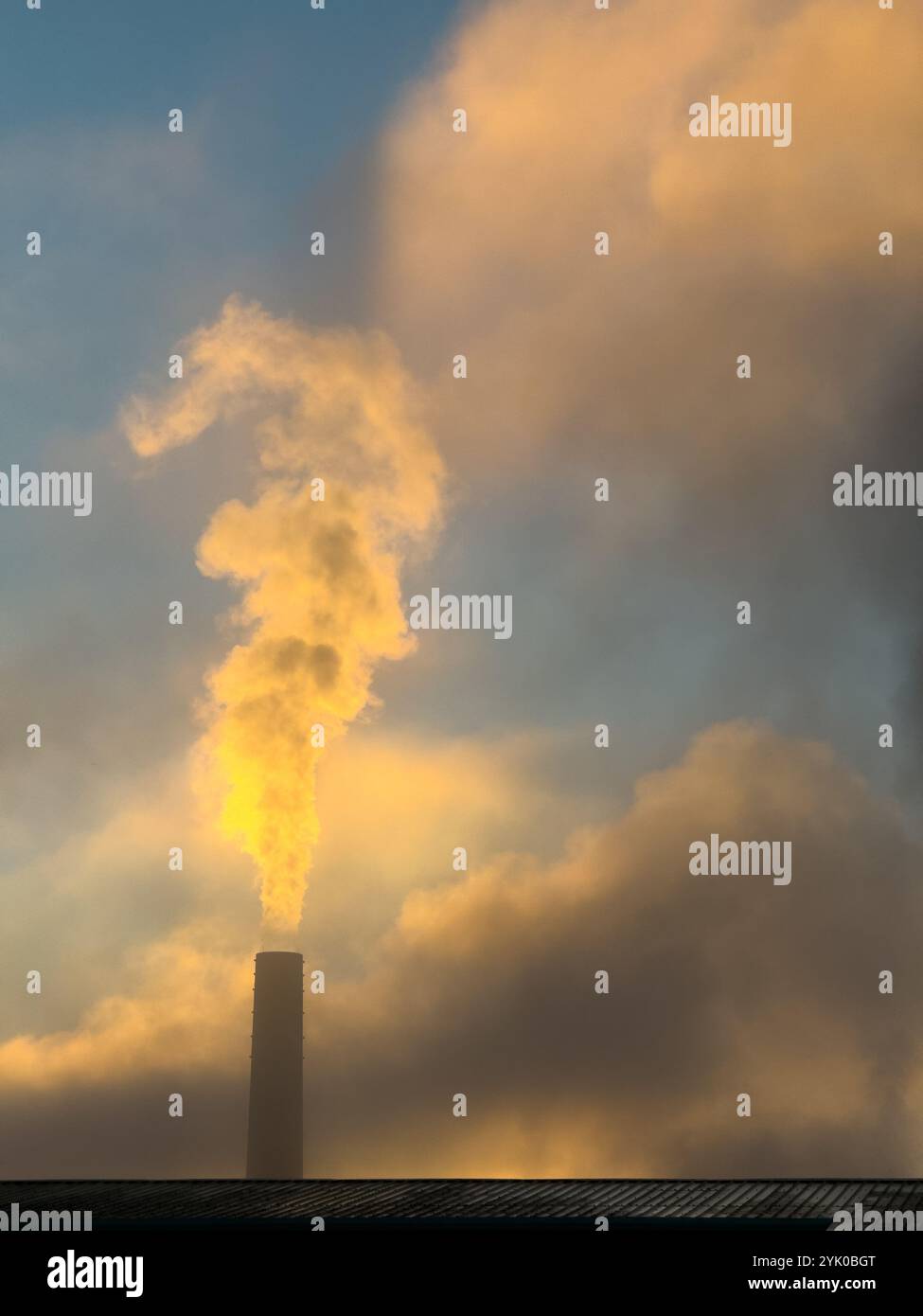 Steam rising from brick chimney stack early on a cold morning, Adlington, Lancashire UK - Smartphone Captured Stock Image