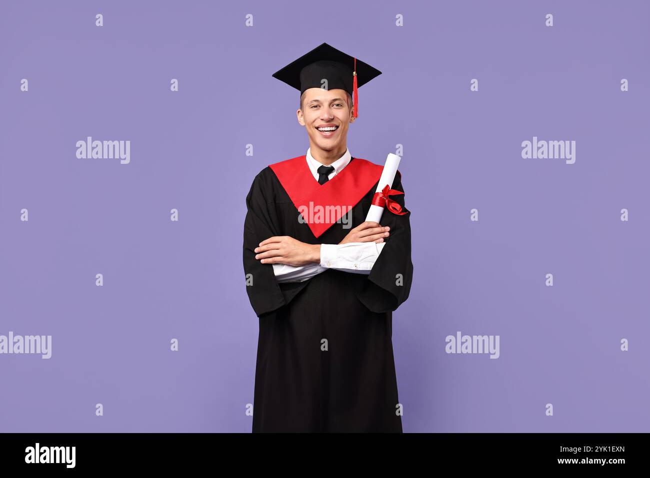 Happy student with diploma after graduation on violet background Stock ...
