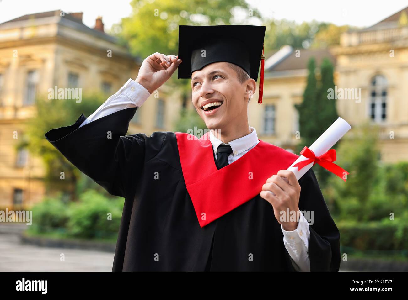 Happy student with diploma after graduation ceremony outdoors Stock ...
