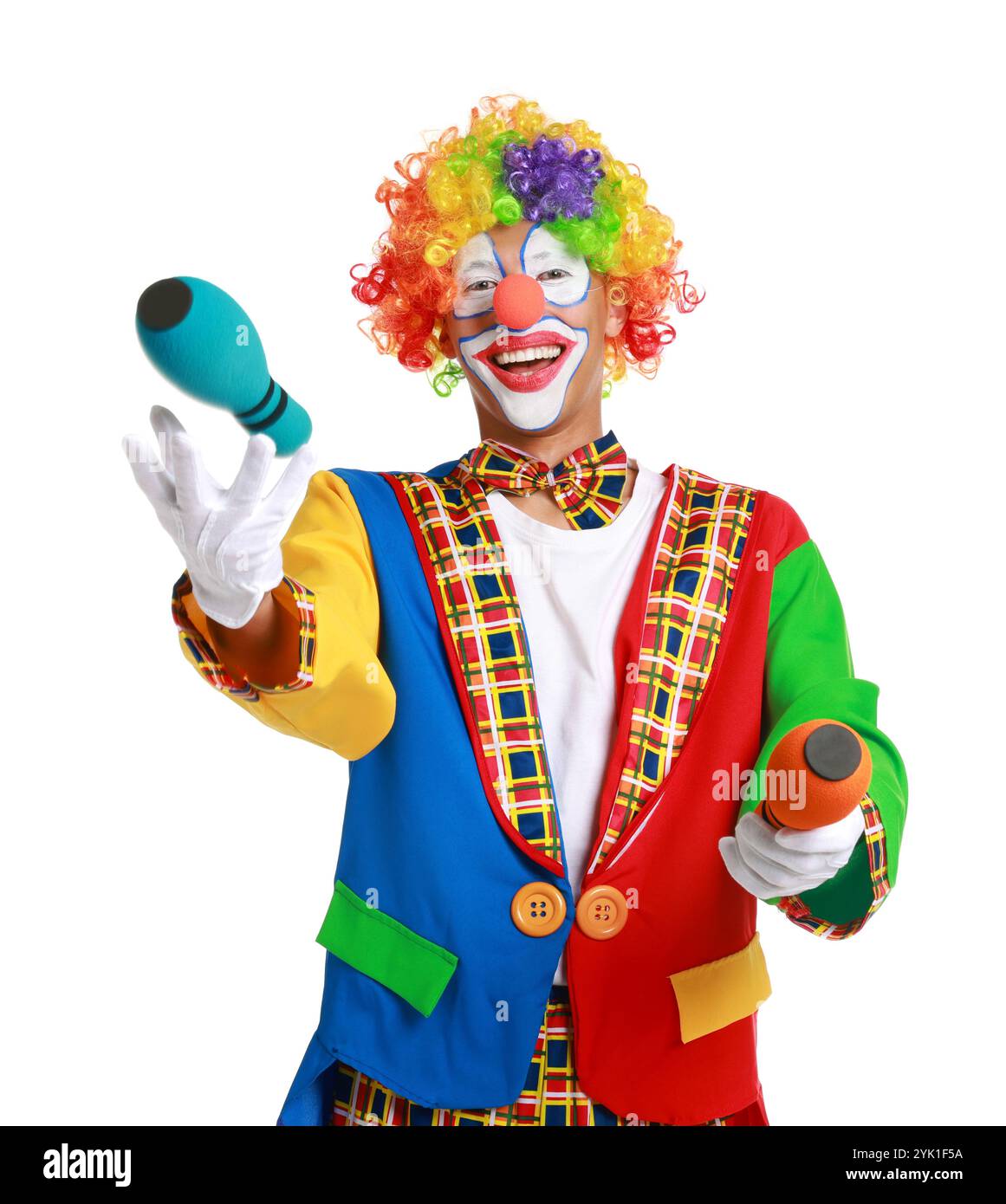 Happy clown juggling clubs on white background Stock Photo - Alamy