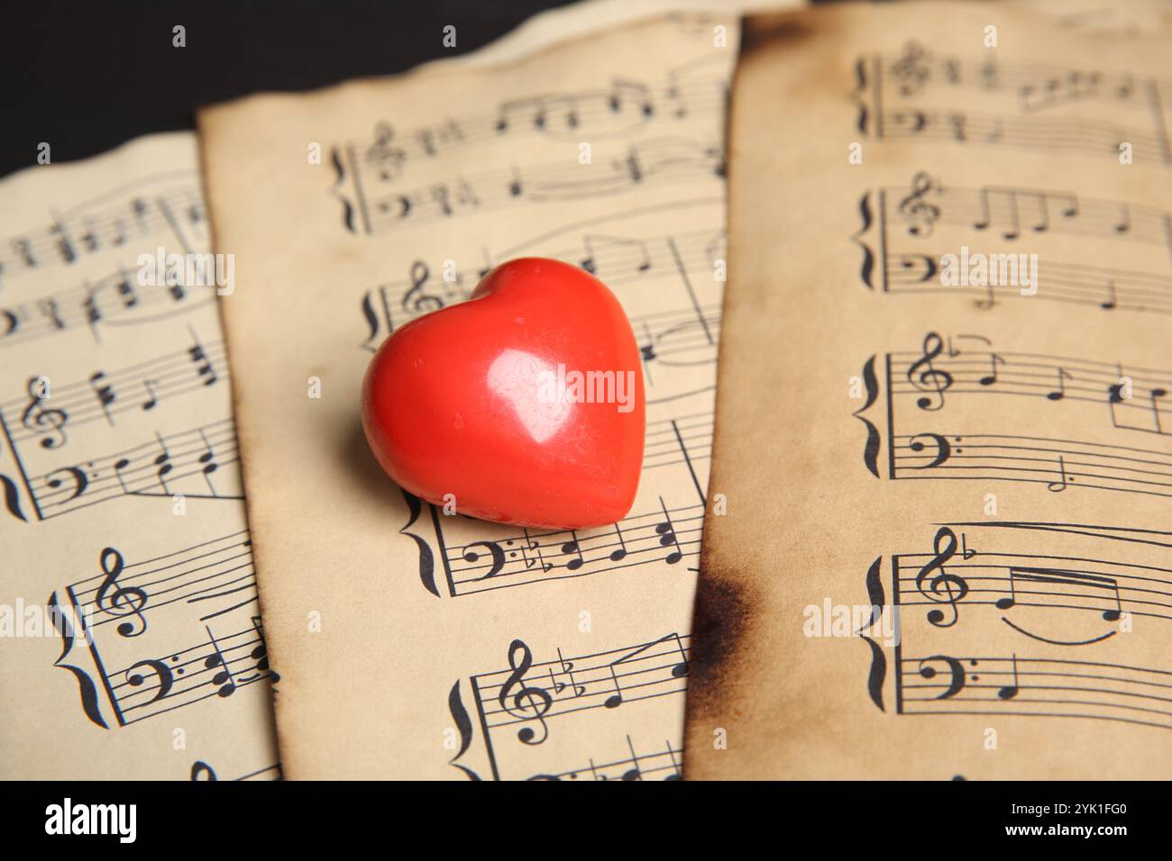 Heart figure on musical note sheets, closeup Stock Photo