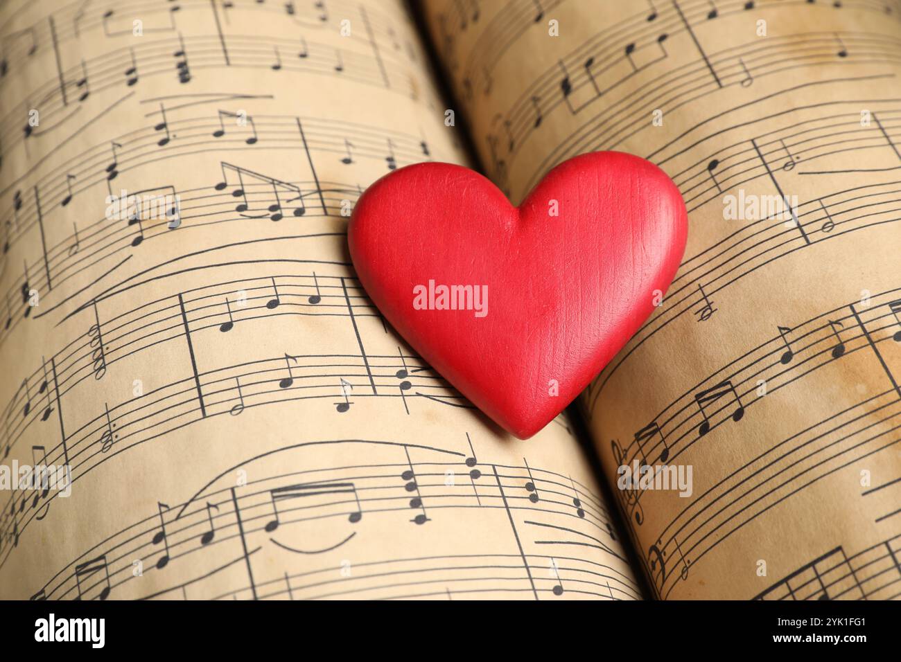 Heart figure on musical note sheets, closeup Stock Photo