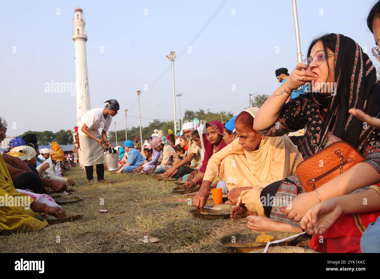 Non Exclusive: Devotees rest while eating on the occasion of the birth ...