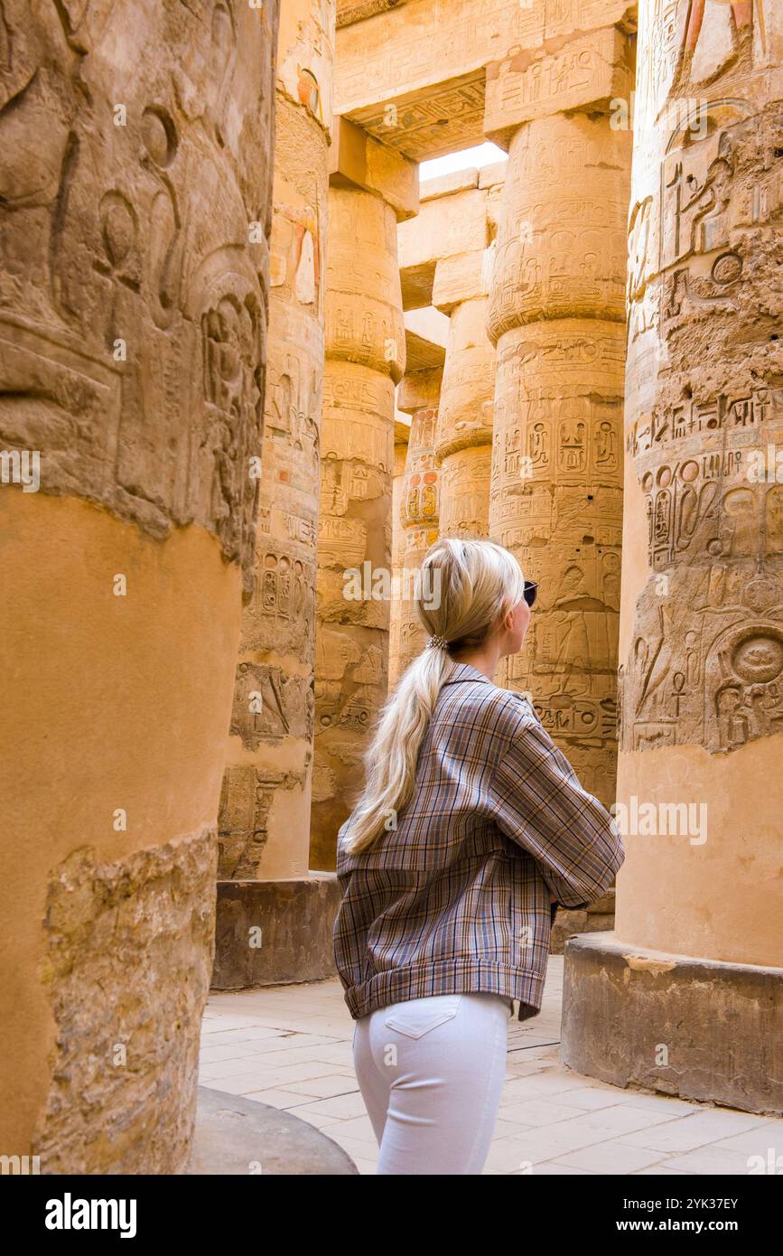 Young woman in the Great Hypostyle Hall in the Precinct of Amon-Re,  Karnak Temple Complex, Luxor, Egypt, Northeast Africa Stock Photo