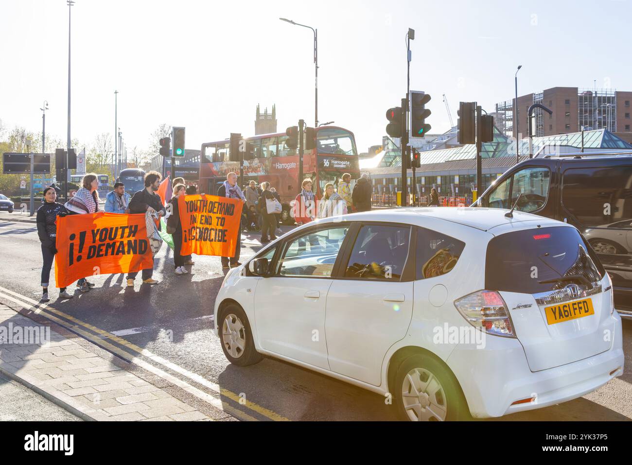 Leeds, UK. 16 NOV, 2024. Activists on the road outside Leeds Bus Station as Youth Demand blocked 2 roads in central Leeds at the end of a week of Pro Palestine actions across the country, following the second action 3 of the activists were effectively banned from the city center as they were issued with S34/S35 orders and escorted to the edge of the city. Credit Milo Chandler/Alamy Live News Stock Photo