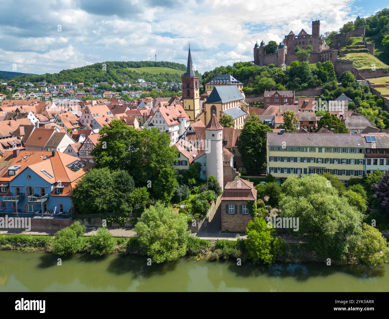 Aerial view of the Tauber river flowing gently past the old town with the Red Tower at the Faultor (Kittsteintor), the Collegiate Church and Wertheim Stock Photo