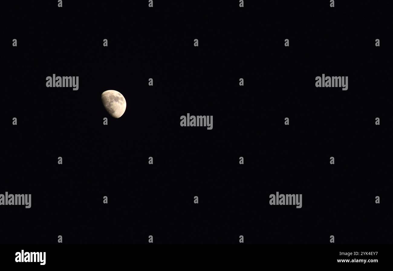 half moon floating on sky in night Stock Photo