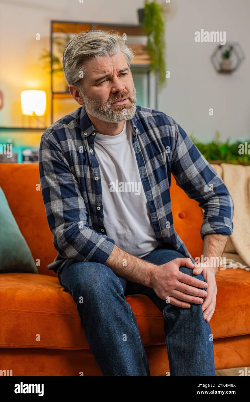 Middle-aged man suffer from painful discomfort severe knee joint ache ...