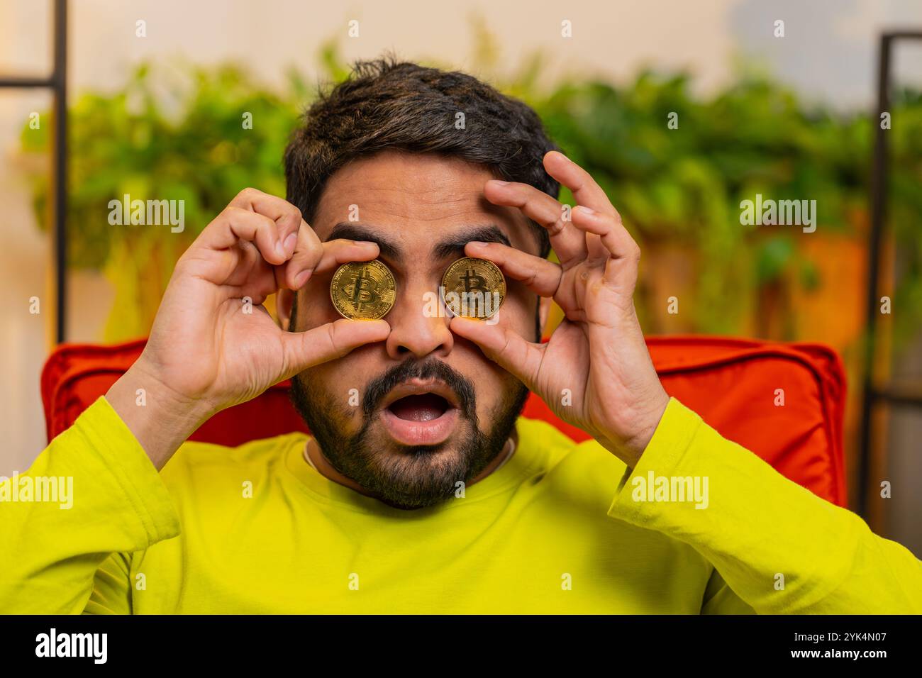 Indian man freelancer holding gold coin successful developer programmer.  Ok. Hindu guy stock trader earning bitcoins after online monitoring trading  operations. Increasing wealth financial prosperity Stock Photo - Alamy