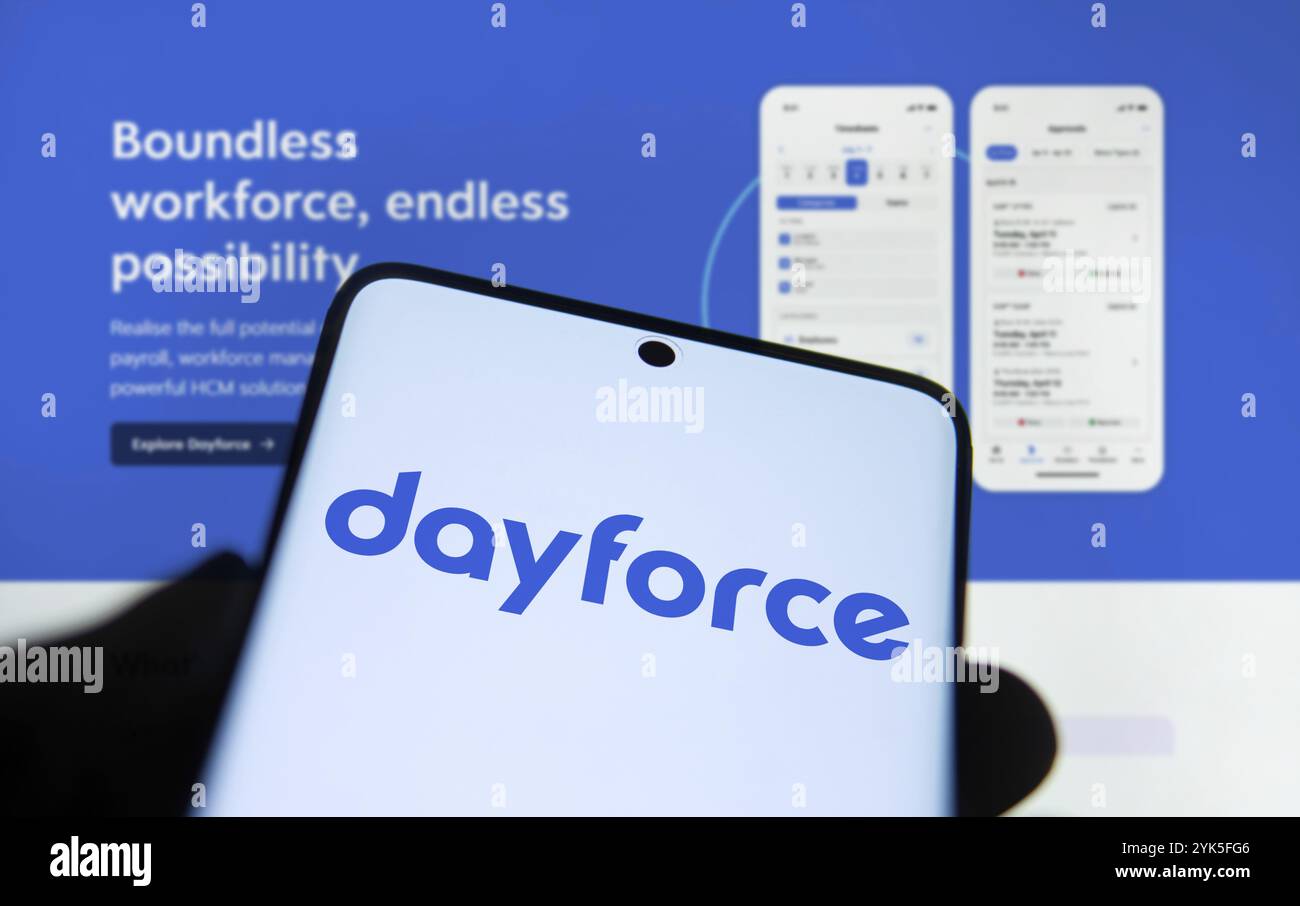 Dayforce logo is displayed on smartphone. Dayforce Inc provides HR
