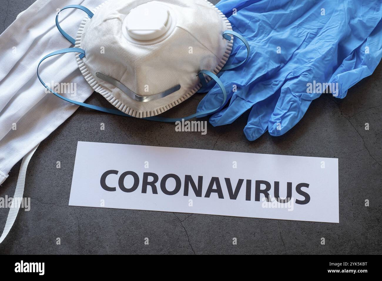 Text phrase Coronavirus on black background with protective medical masks, gloves and respirator masks FFP2 for coronavirus epidemic Stock Photo