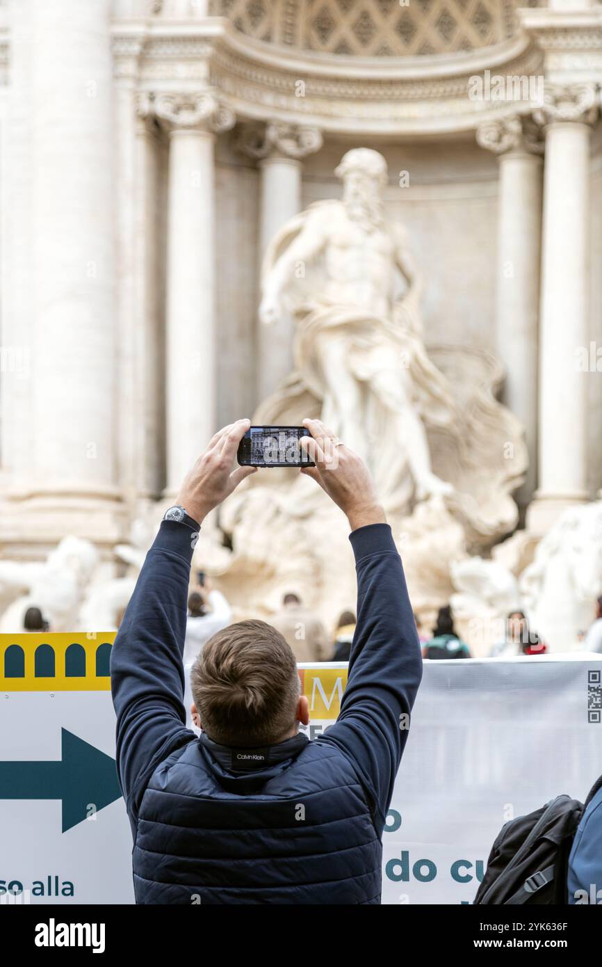 Rome, Italy - Nov 14th, 2024: A visitor photographs the Trevi Fountain ...