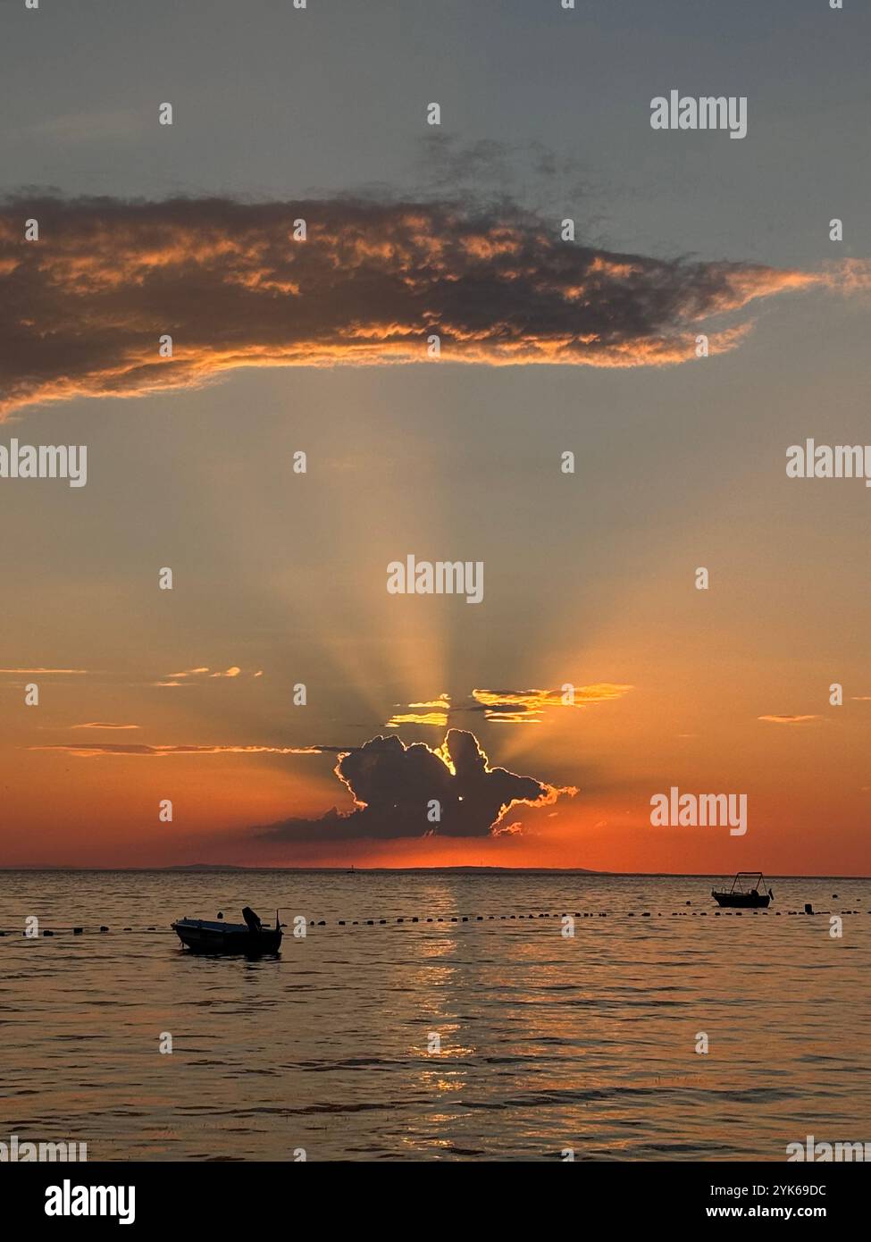 Beautiful sunset behind the clouds, over sea, Turkiye, Turkey - Smartphone Captured Stock Image