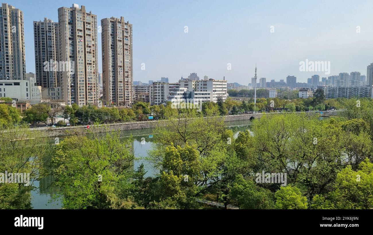 A serene cityscape of Yichun, China, captured from a temple overlooking a river. - Smartphone Captured Stock Image