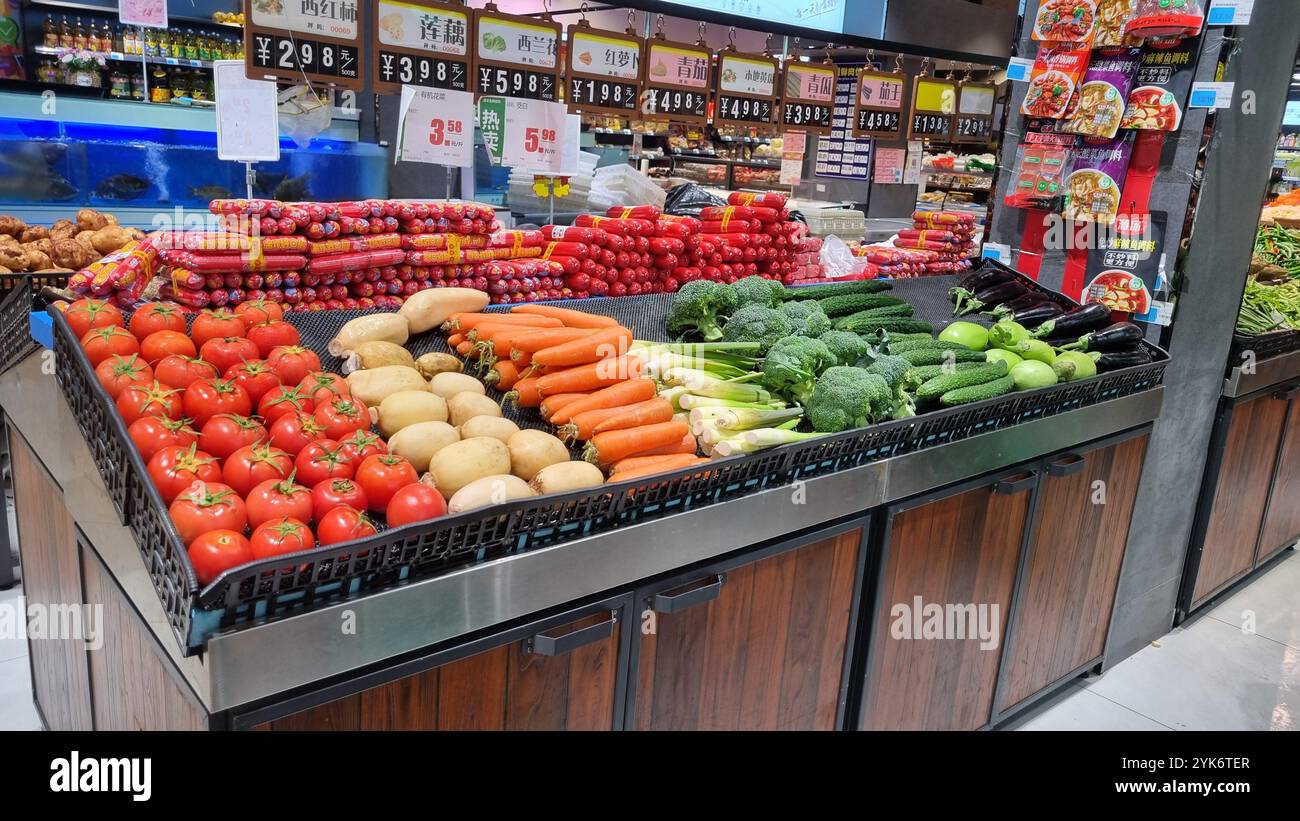 This image shows a well-stocked produce section in a Chinese supermarket. - Smartphone Captured Stock Image