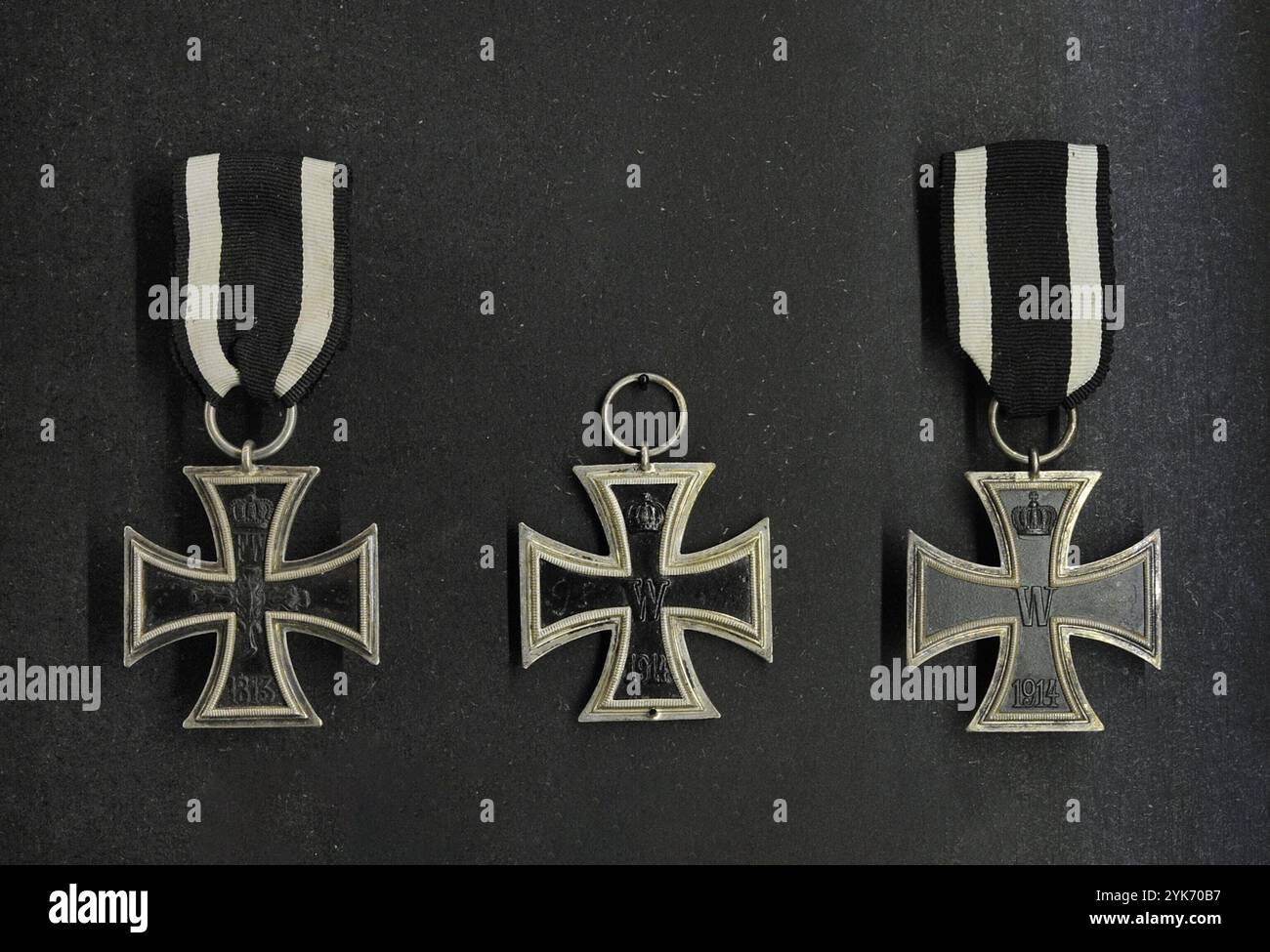 Iron Cross. Military decoration in the Kingdom of Prussia, German Empire (1871-1918) and Nazi Germany (1933-1945). Iron Crosses 2nd Class (most common, awarded for acts of bravery on the battlefield). From left to right: Iron Cross designed in 1813 (Napoleonic Wars) and Iron Crosses designed in 1914 (World War I). Latvian War Museum. Riga. Latvia. Stock Photo