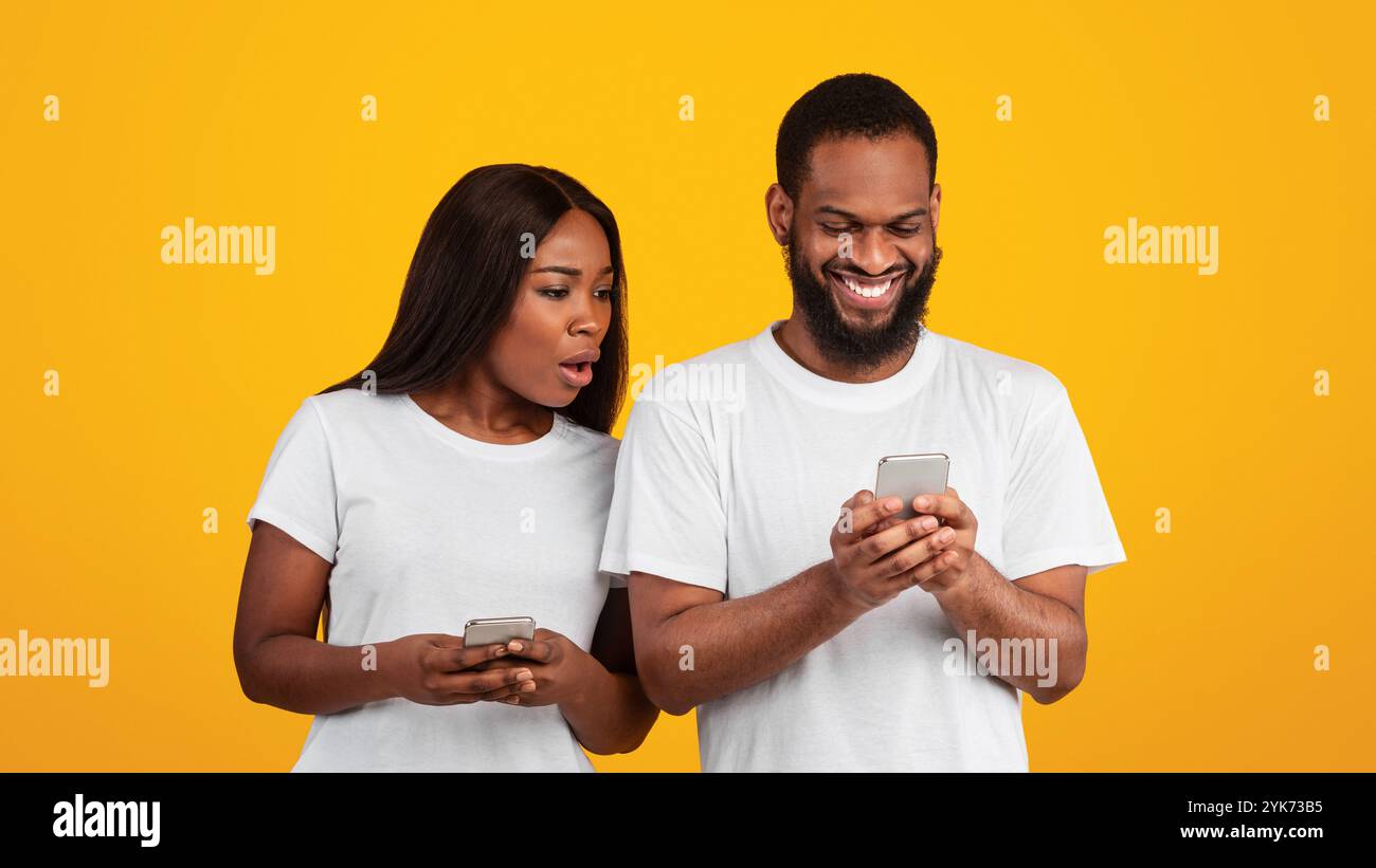 Black woman checking his boyfriend mobile phone Stock Photo - Alamy