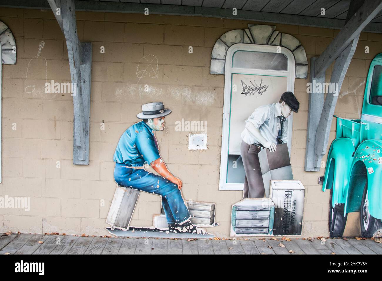 Historic mural men loading boxes into pickup truck at Windsor Sculpture Garden park in Windsor, Ontario, Canada Stock Photo